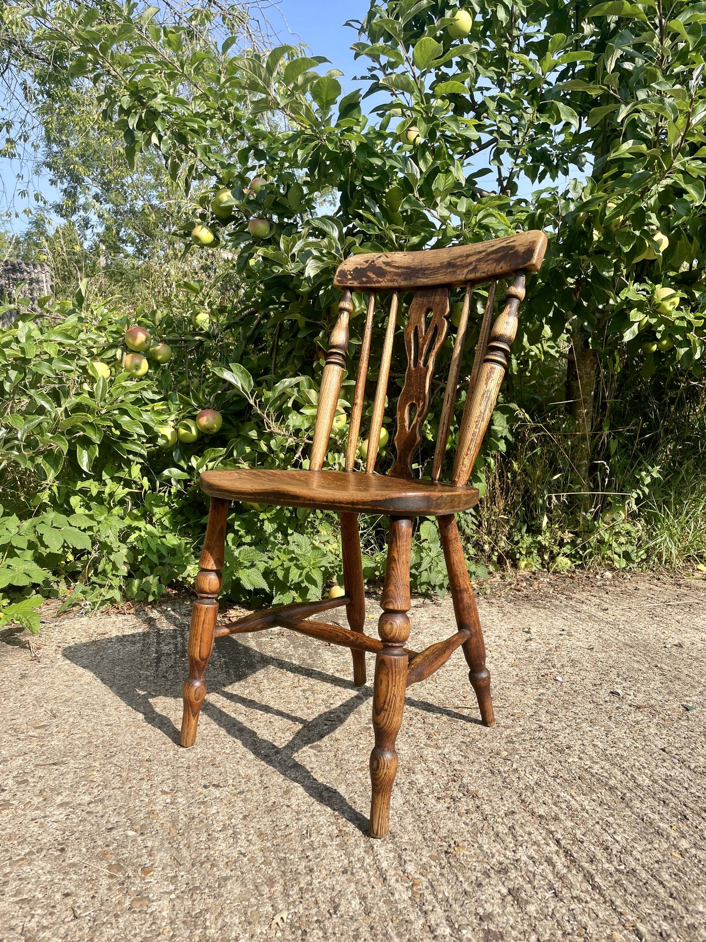 Wooden chair outdoors with greenery in the background