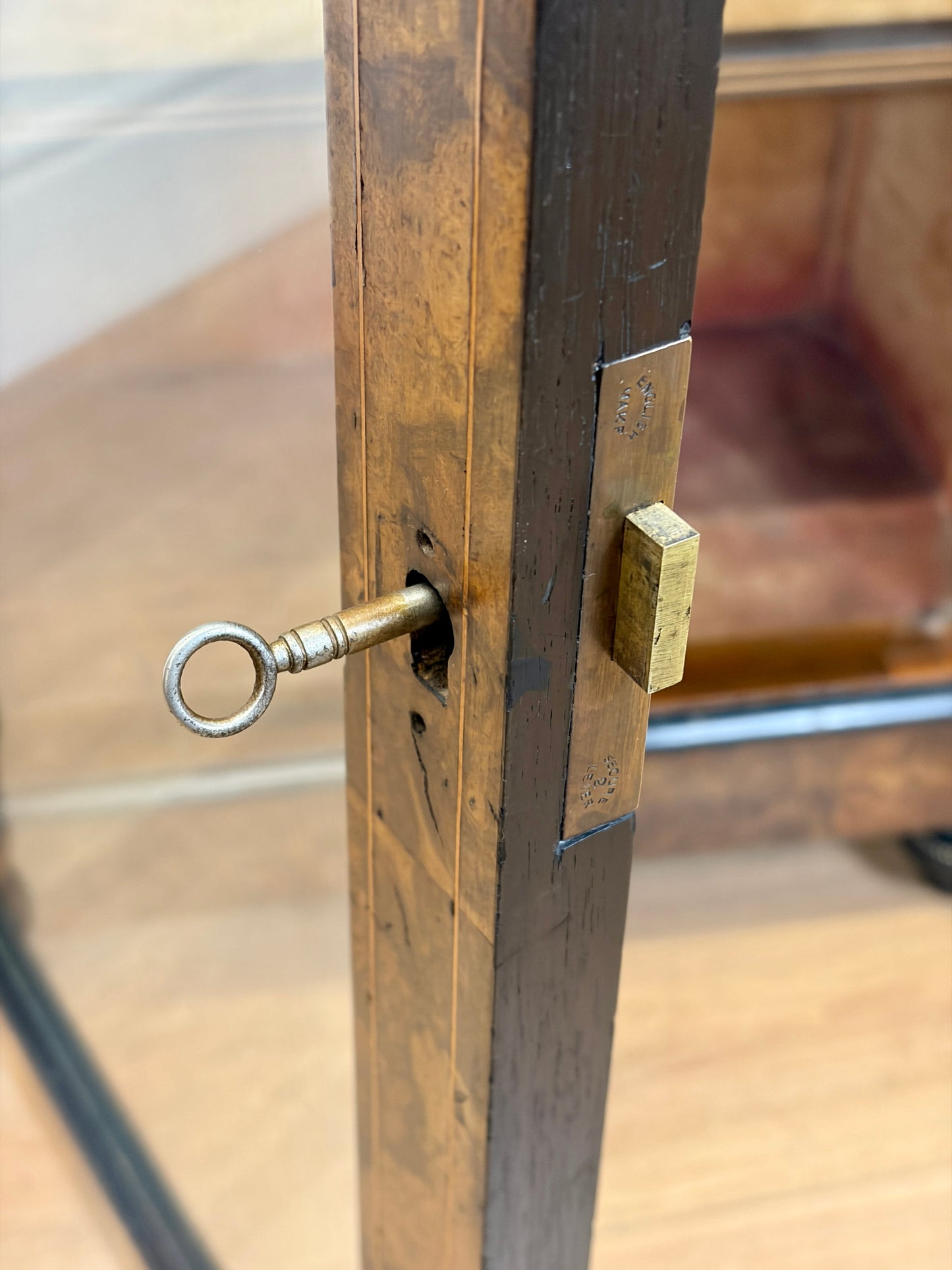 Close-up of a brass door handle with keyhole on a glass door
