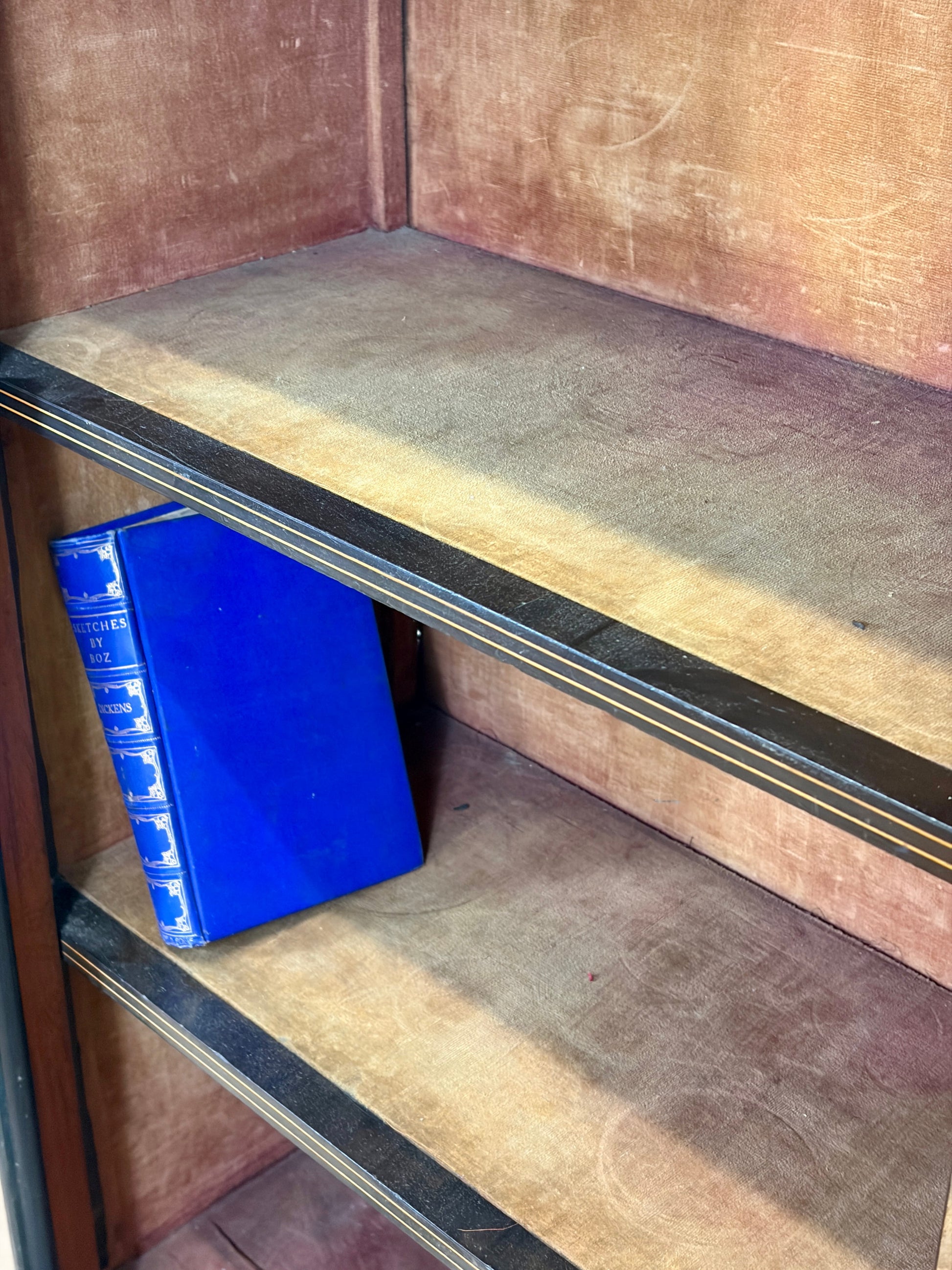 Blue book on a wooden shelf with a worn-out surface