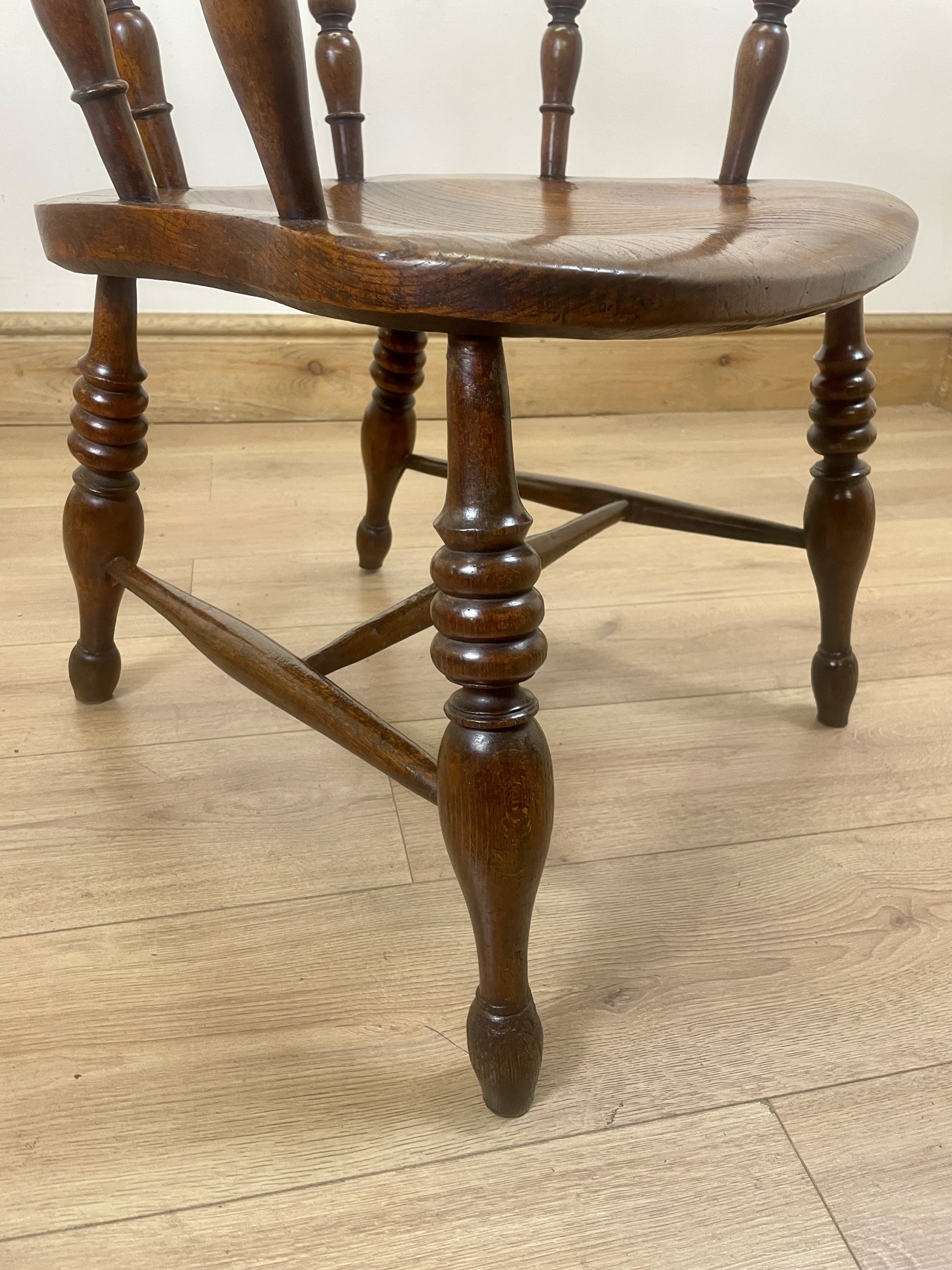 Wooden chair with spindle back on a wooden floor