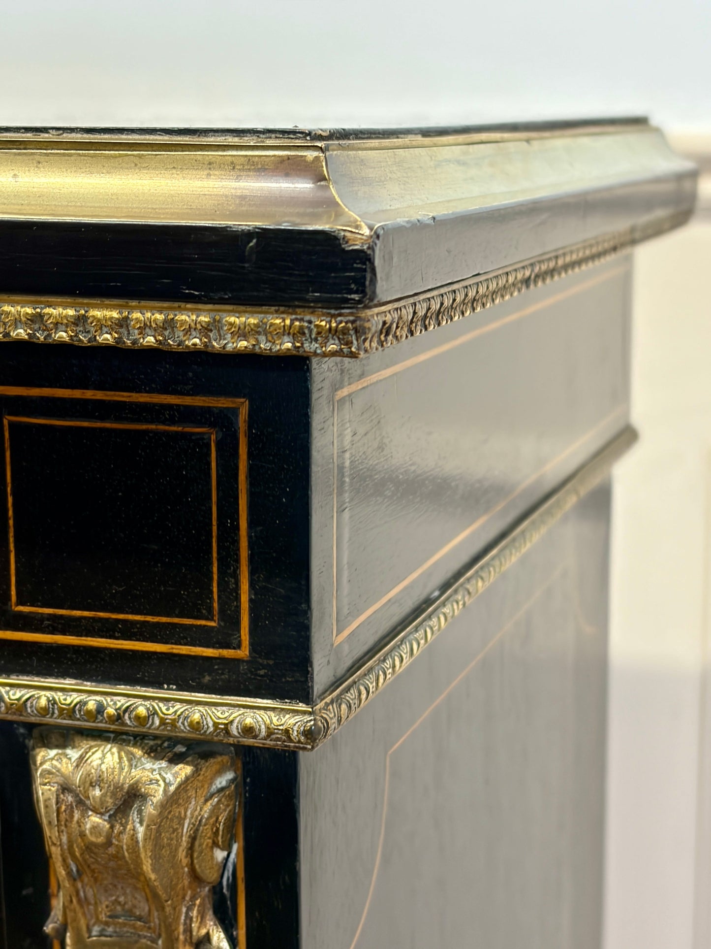 Decorative fireplace with black and gold trim on a white background