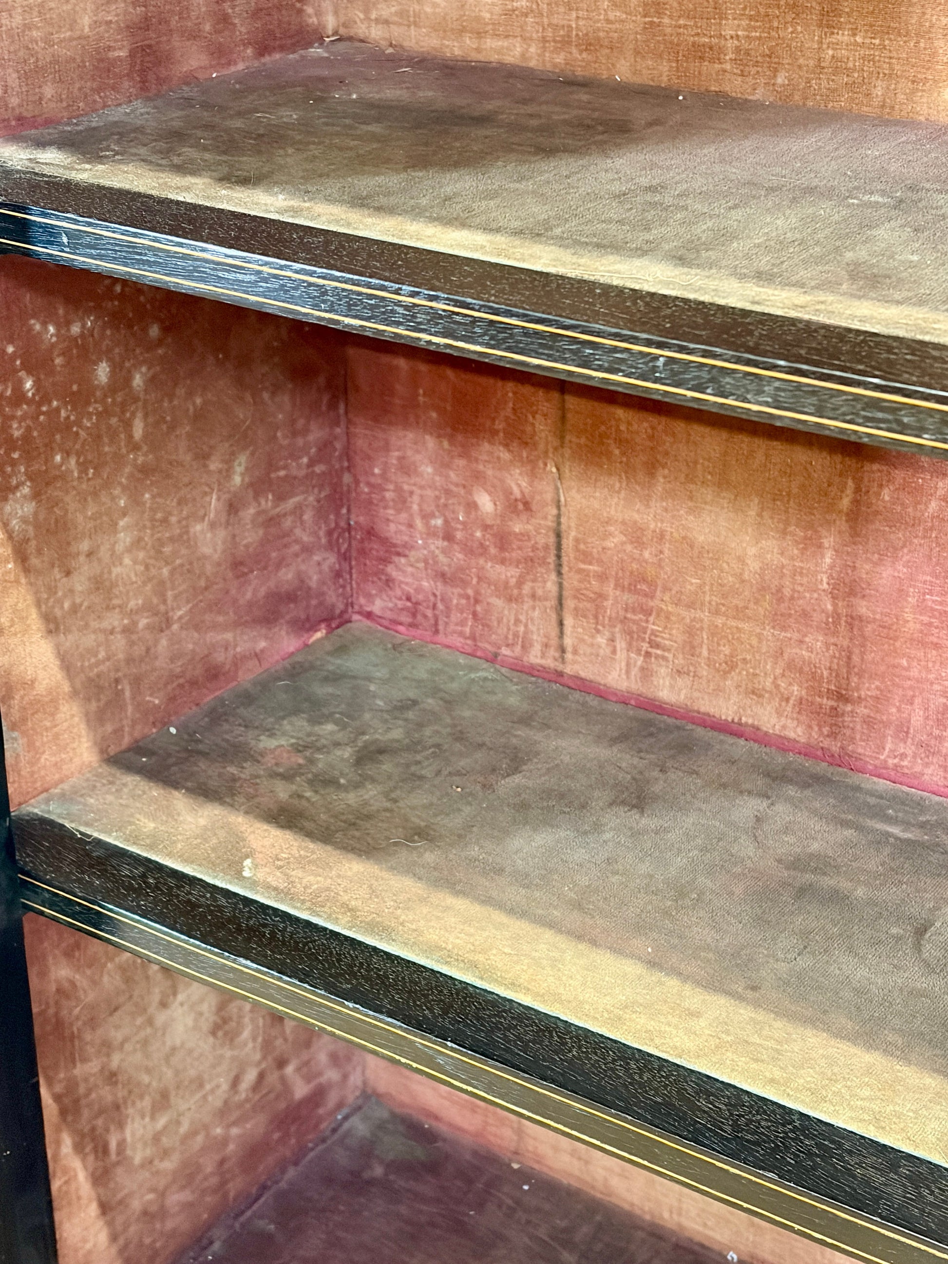 Corner of a wooden bookshelf with metal brackets