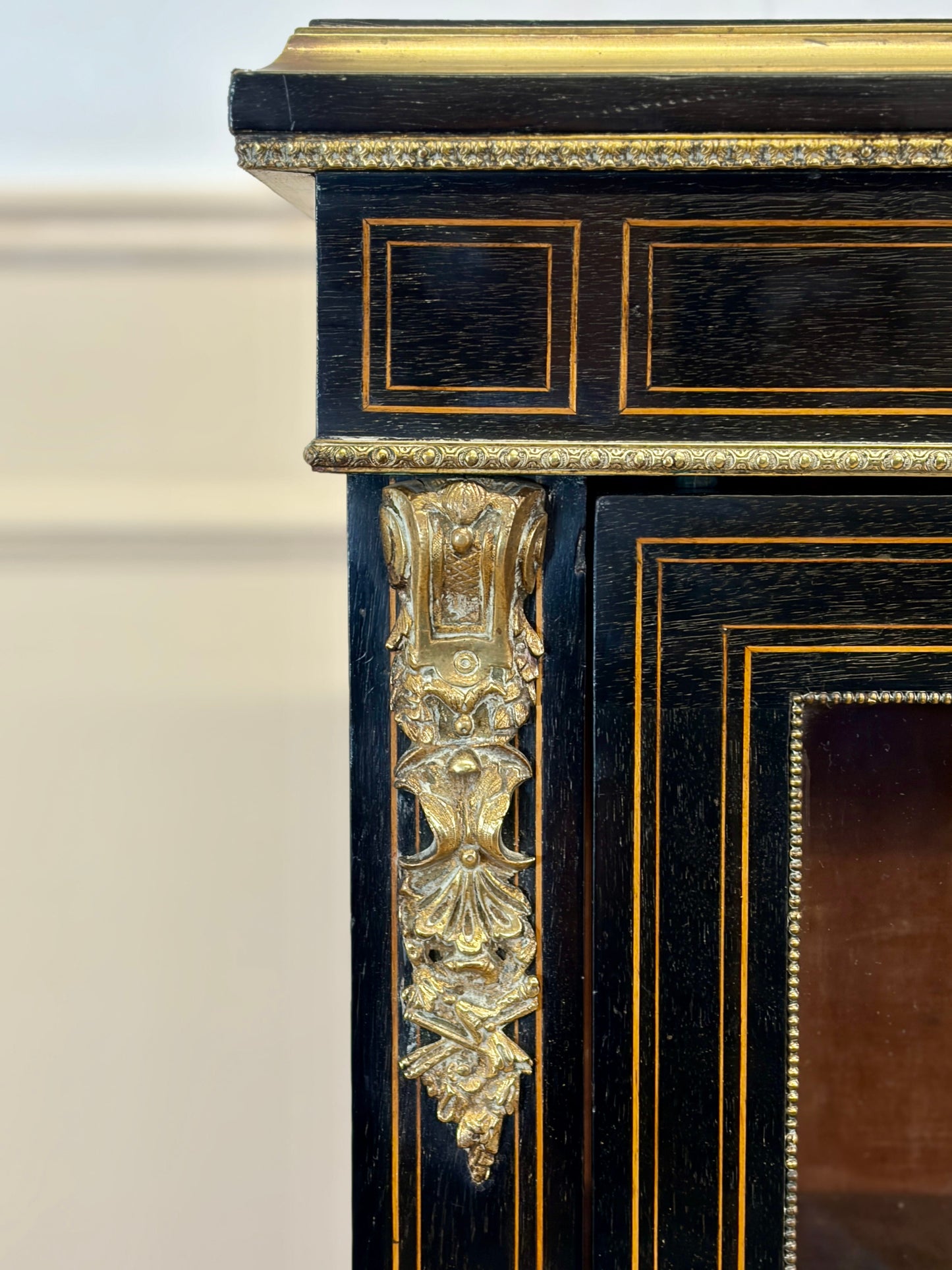 Decorative black and gold cabinet with intricate detailing