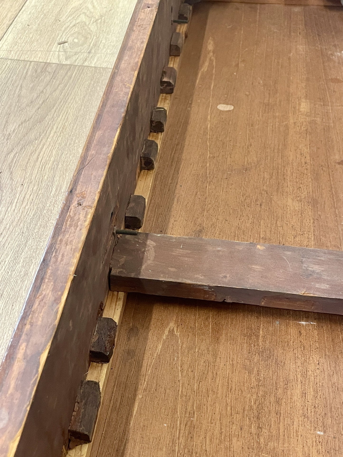 Close-up of a wooden frame corner with visible grain and texture.