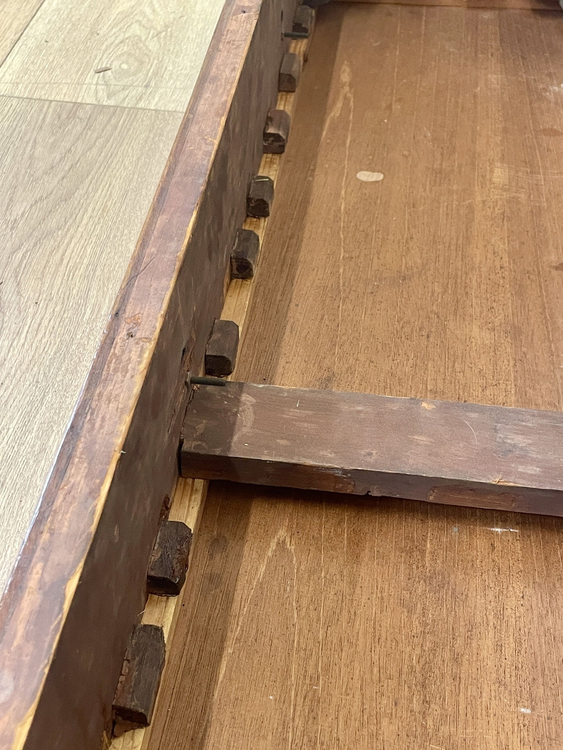 Close-up of a wooden frame corner with visible grain and texture.
