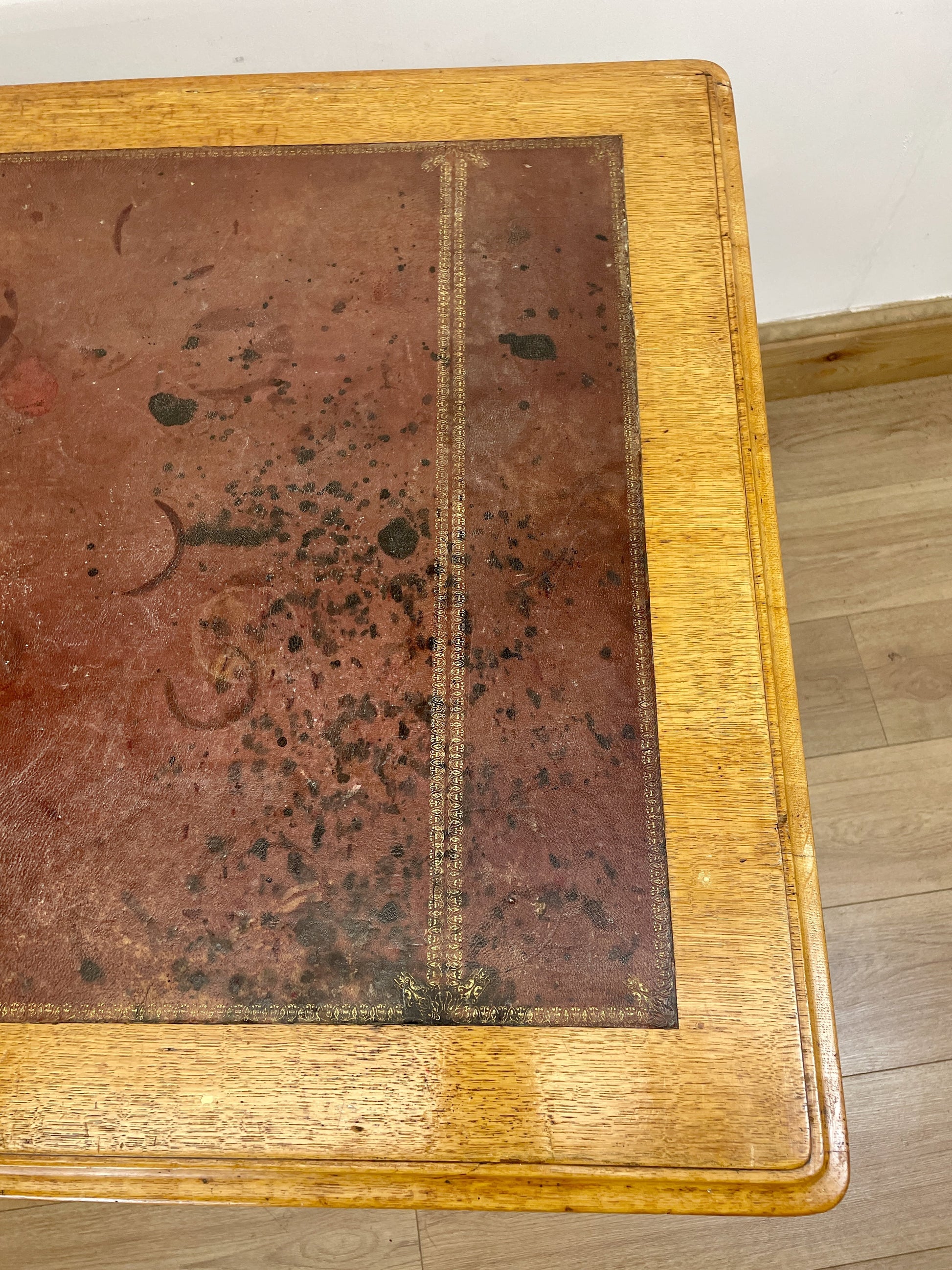 Wooden table with a worn leather surface
