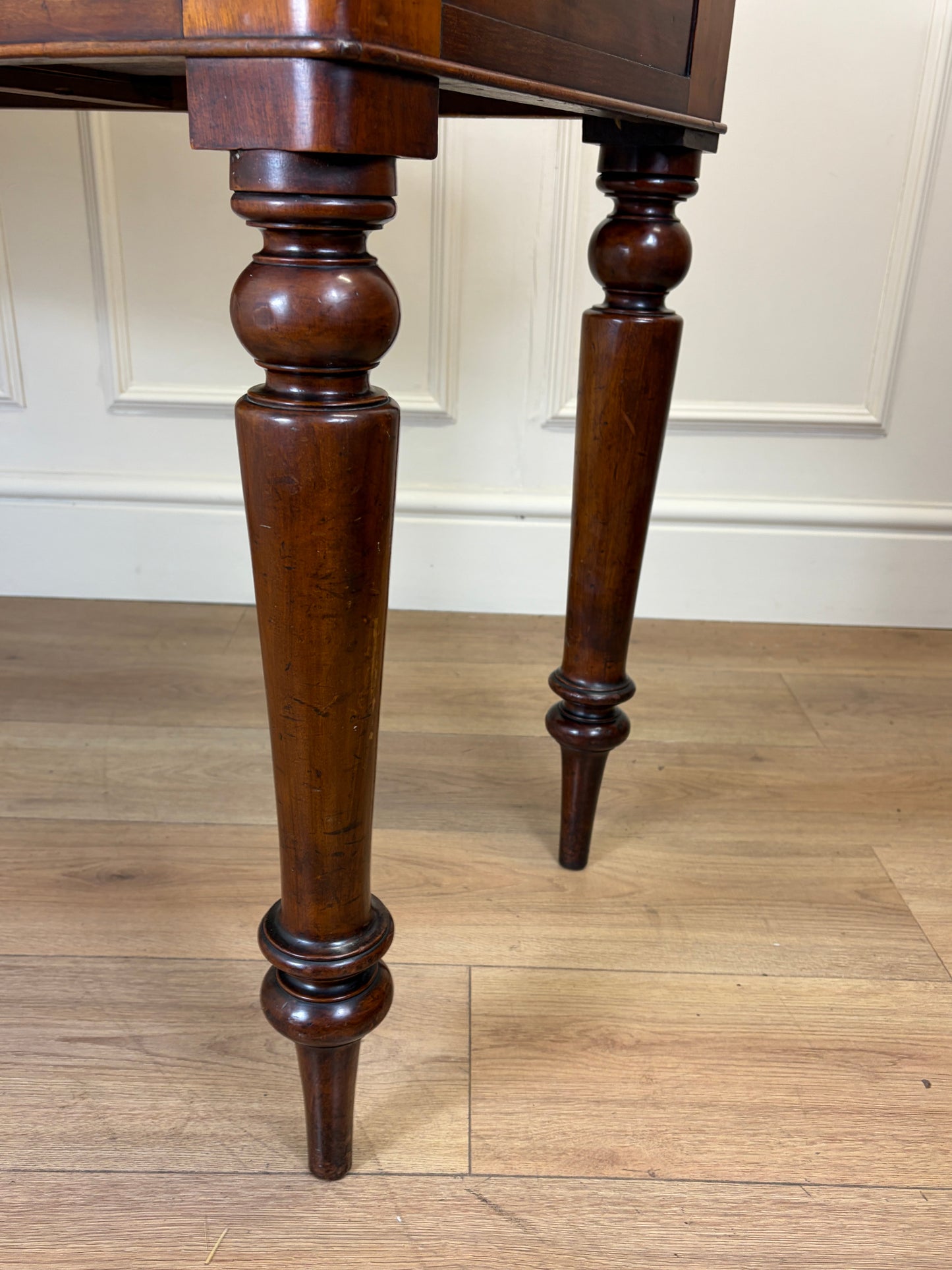 Wooden table with turned legs on a wooden floor