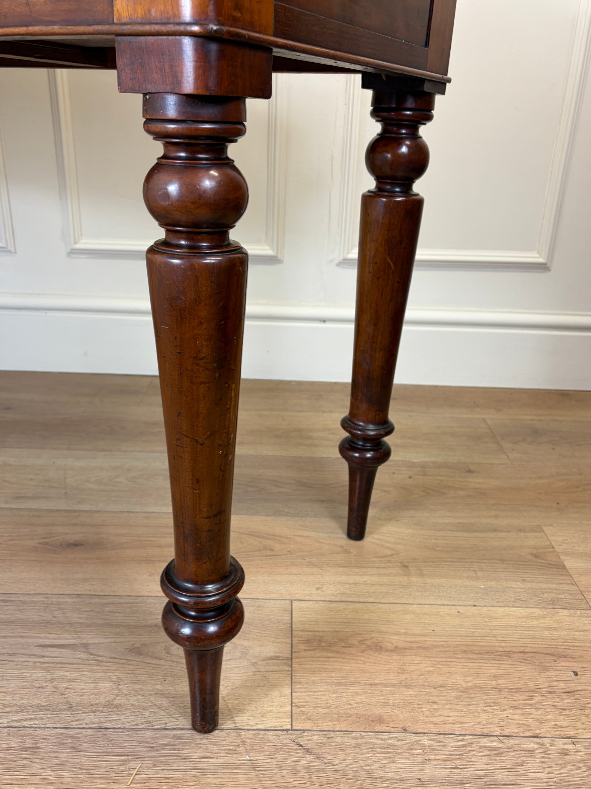 Wooden table with turned legs on a wooden floor
