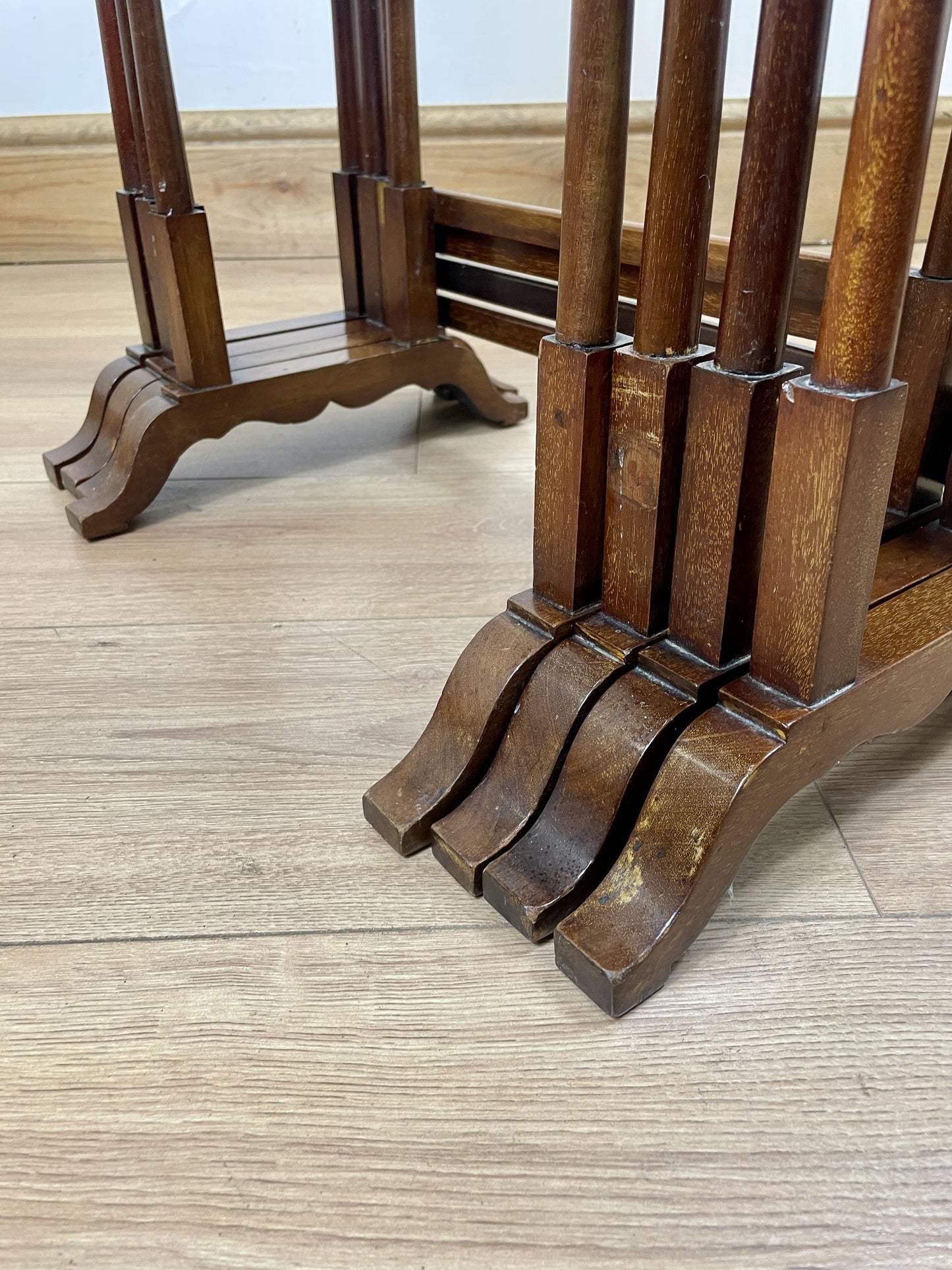 Wooden stand with decorative legs on a wooden floor