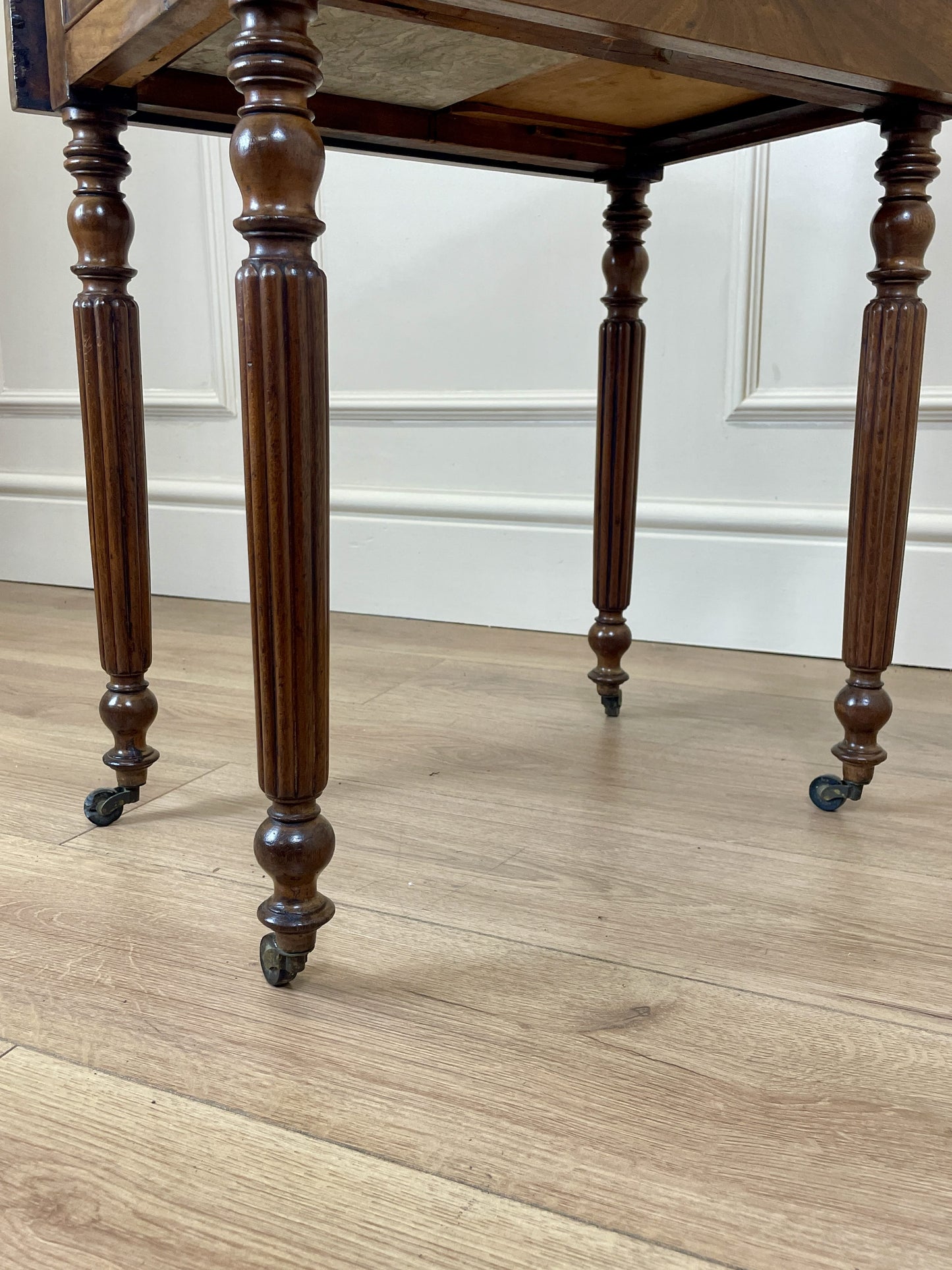 Wooden table with turned legs on a wooden floor