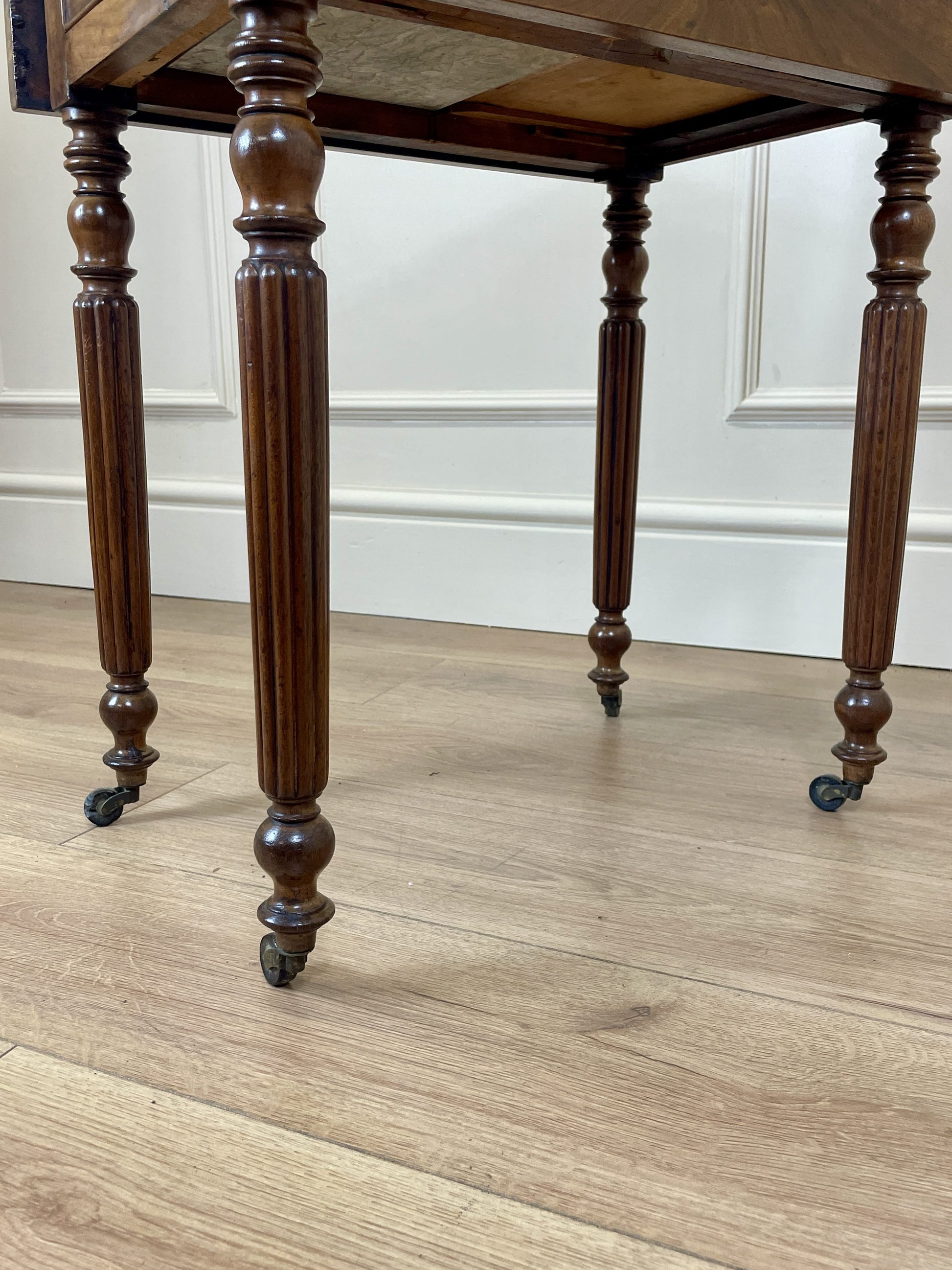 Wooden table with turned legs on a wooden floor