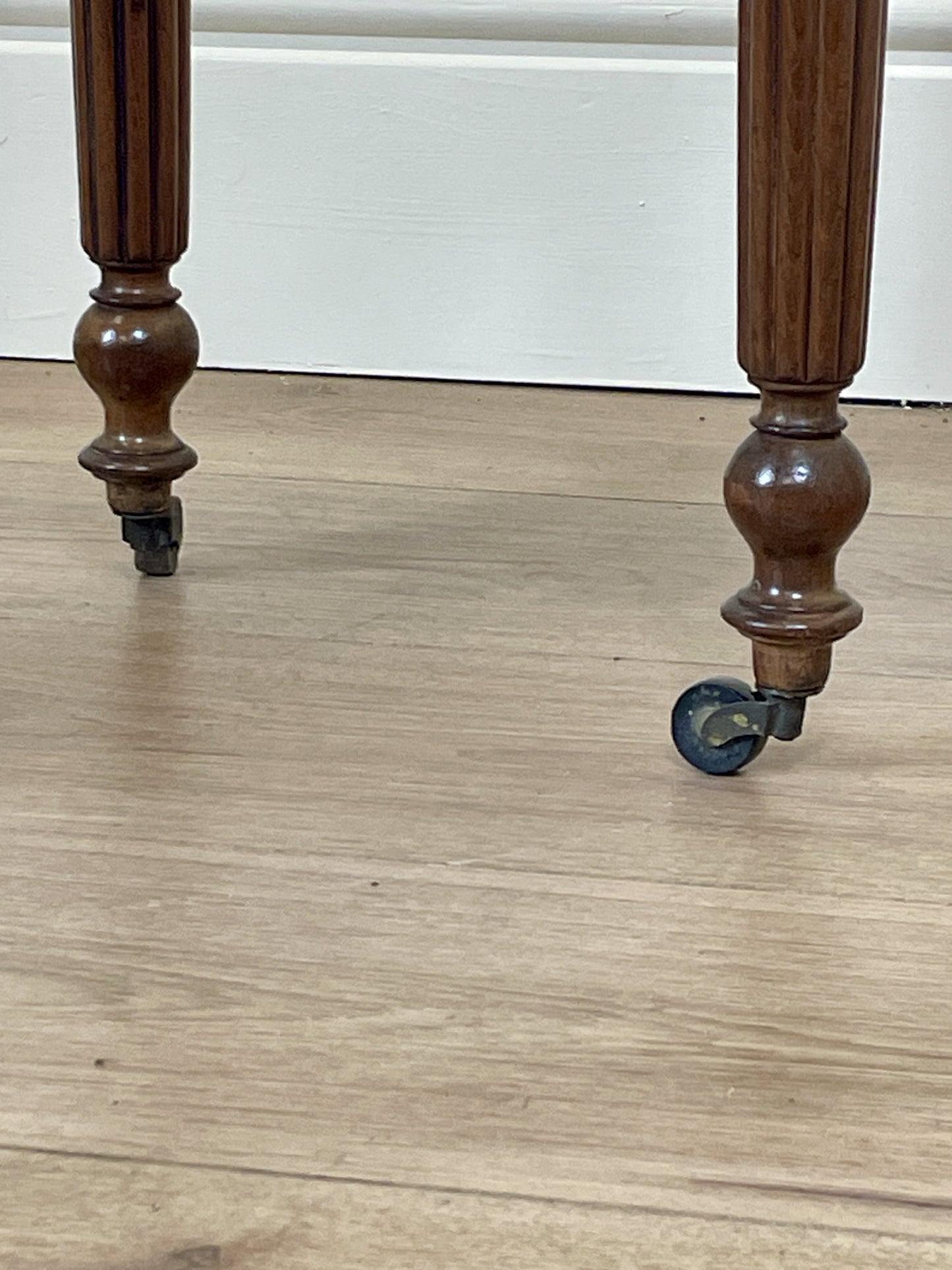 Wooden legs with wheels on a wooden floor