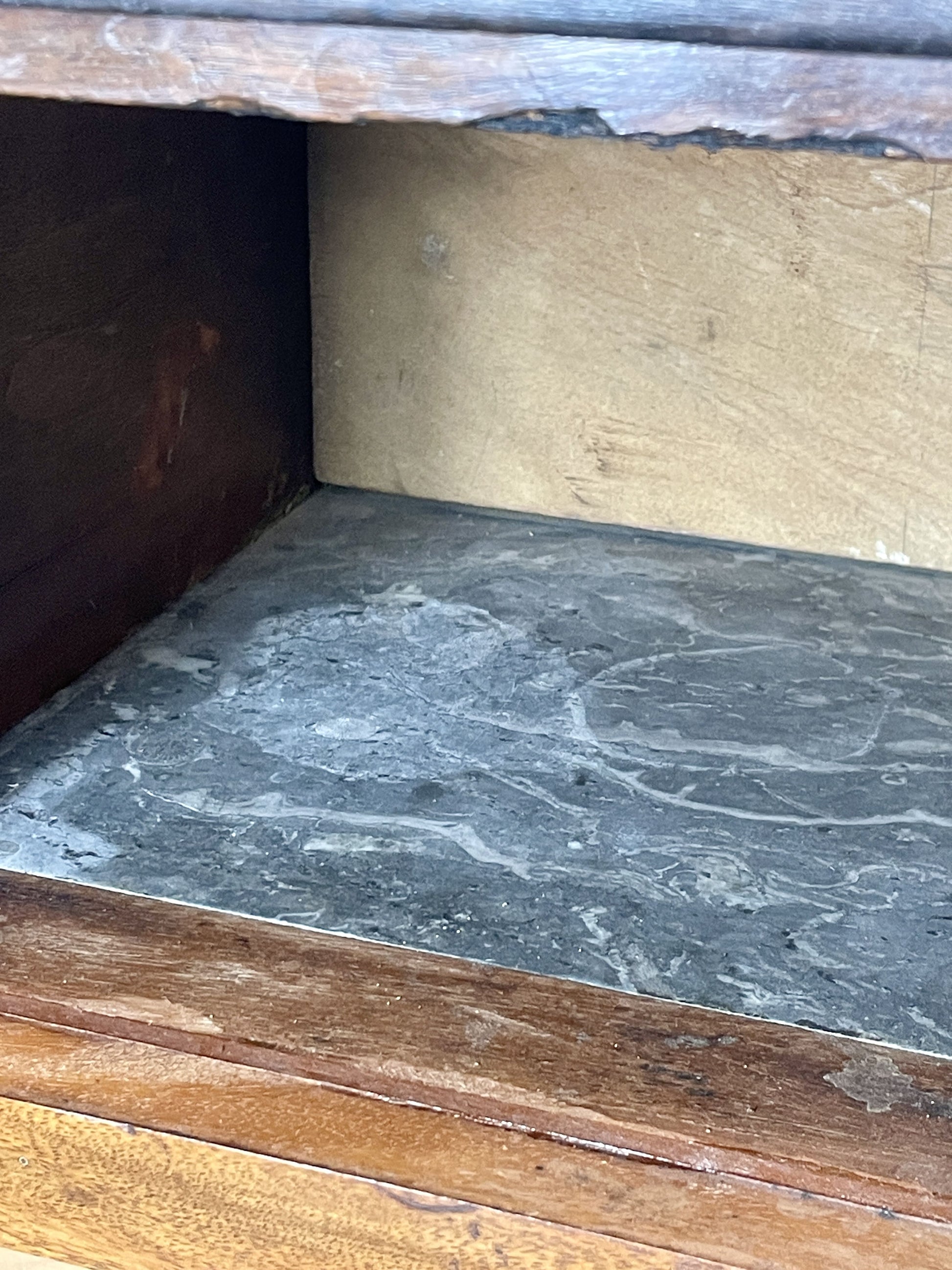 Close-up of a wooden shelf with a dark surface