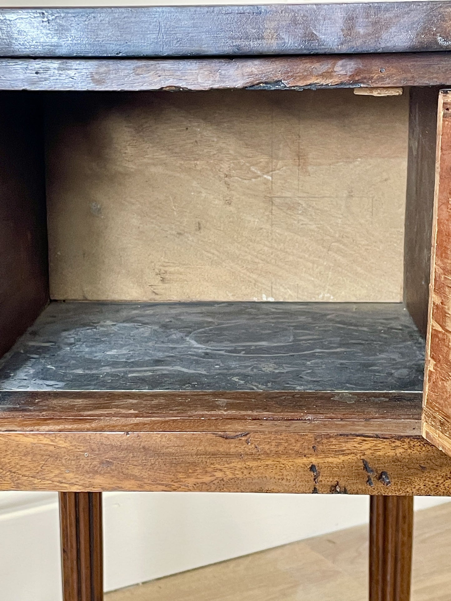 Wooden shelf with a metal top on a plain background