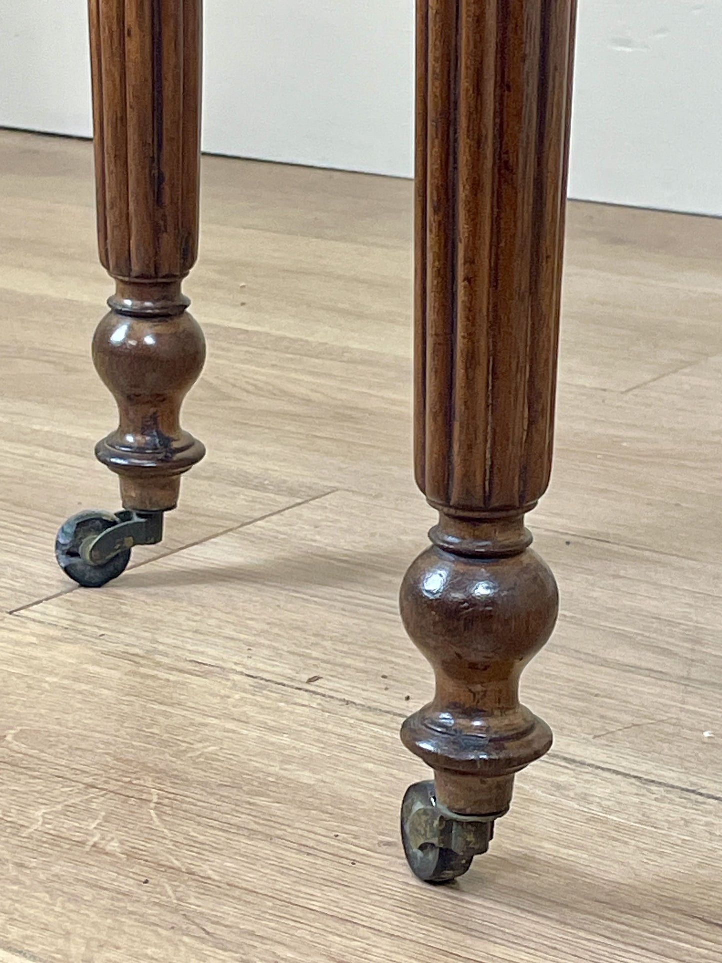 Wooden leg with wheels on a wooden floor