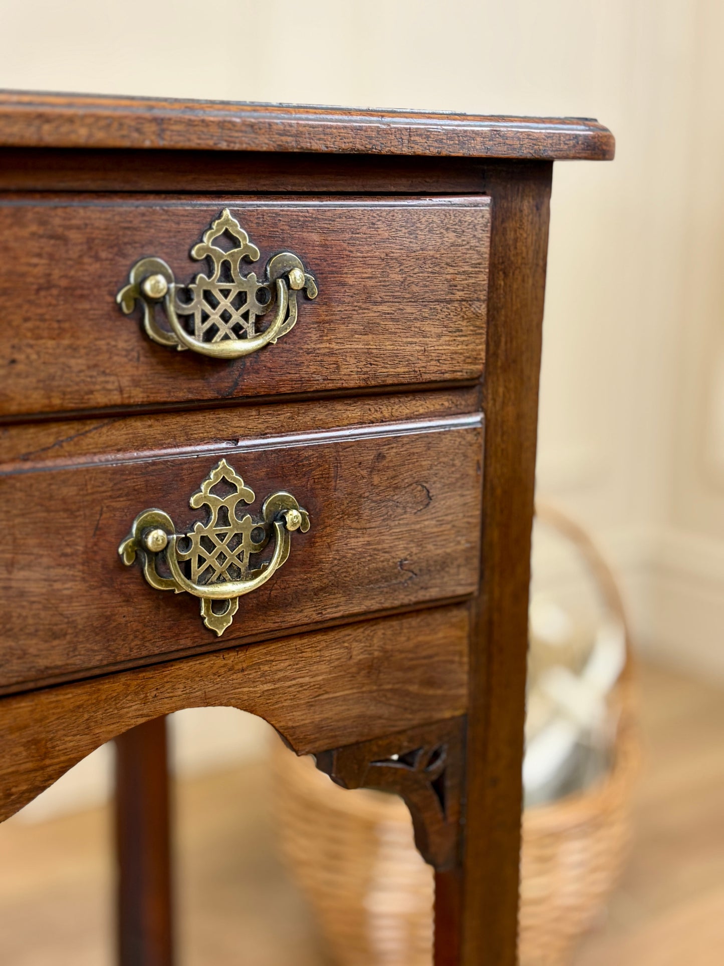 Wooden drawer with brass handles on a blurred background