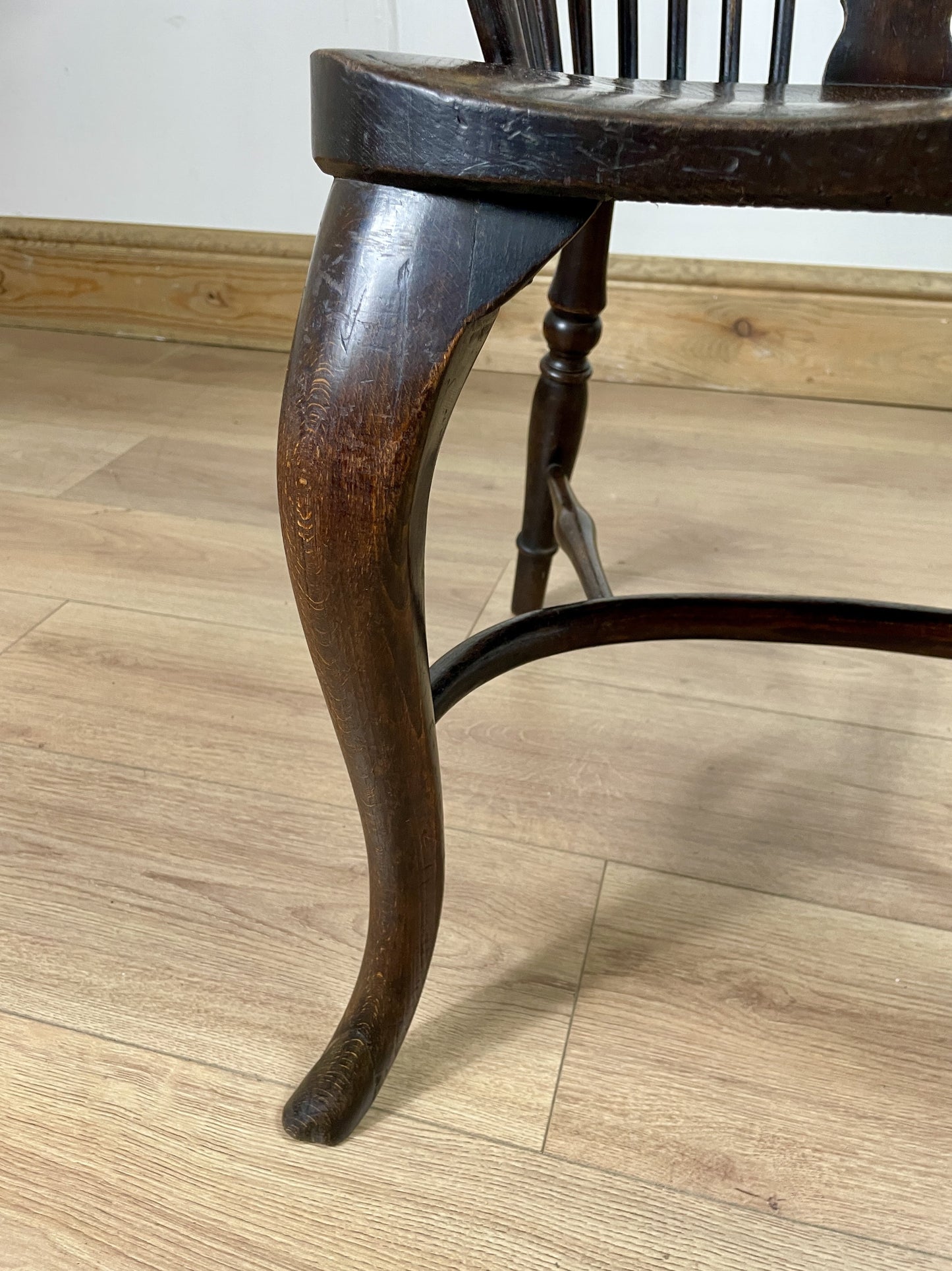 Close-up of a wooden chair leg on a wooden floor