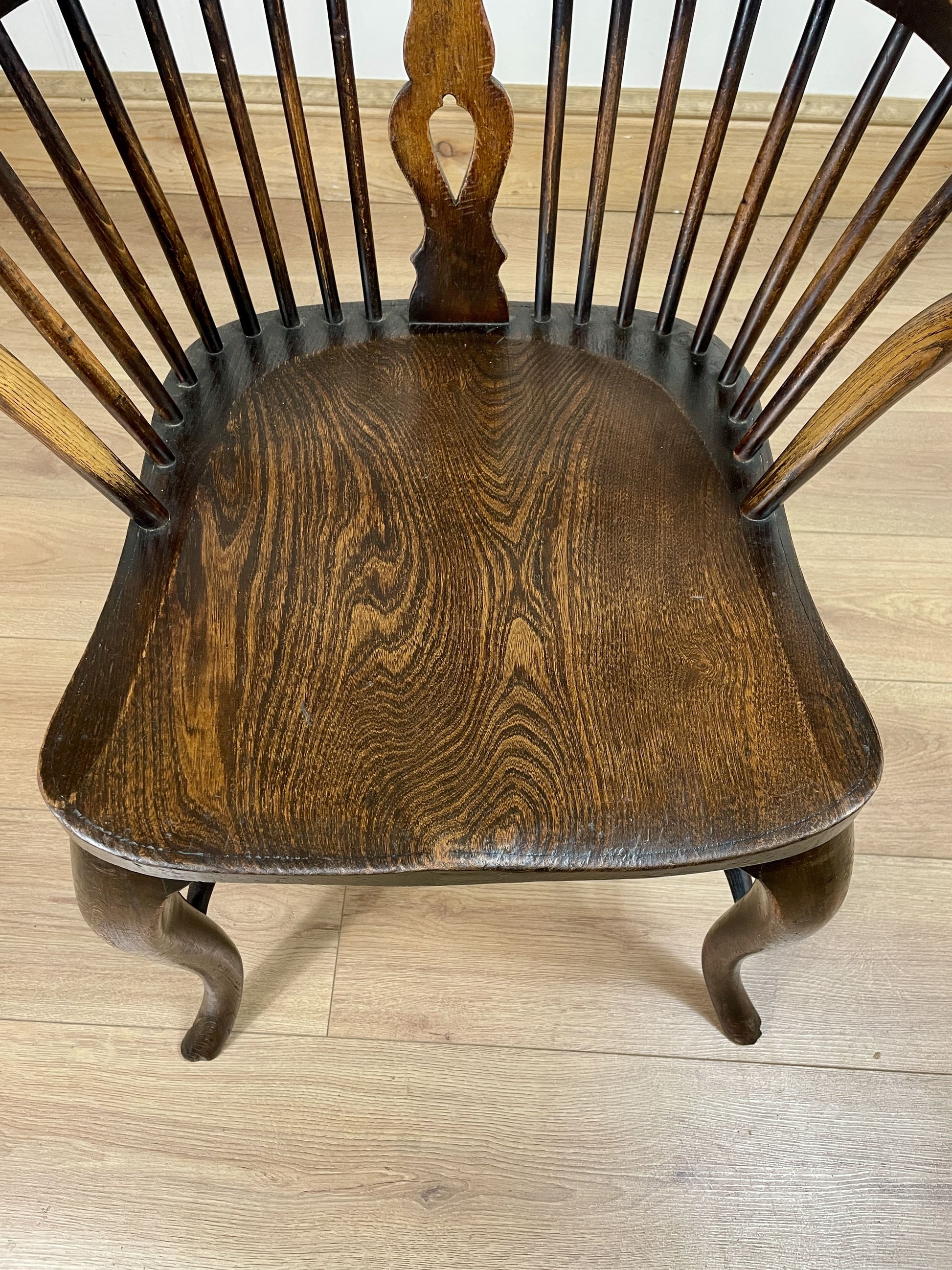 Wooden chair with a spindle back on a wooden floor