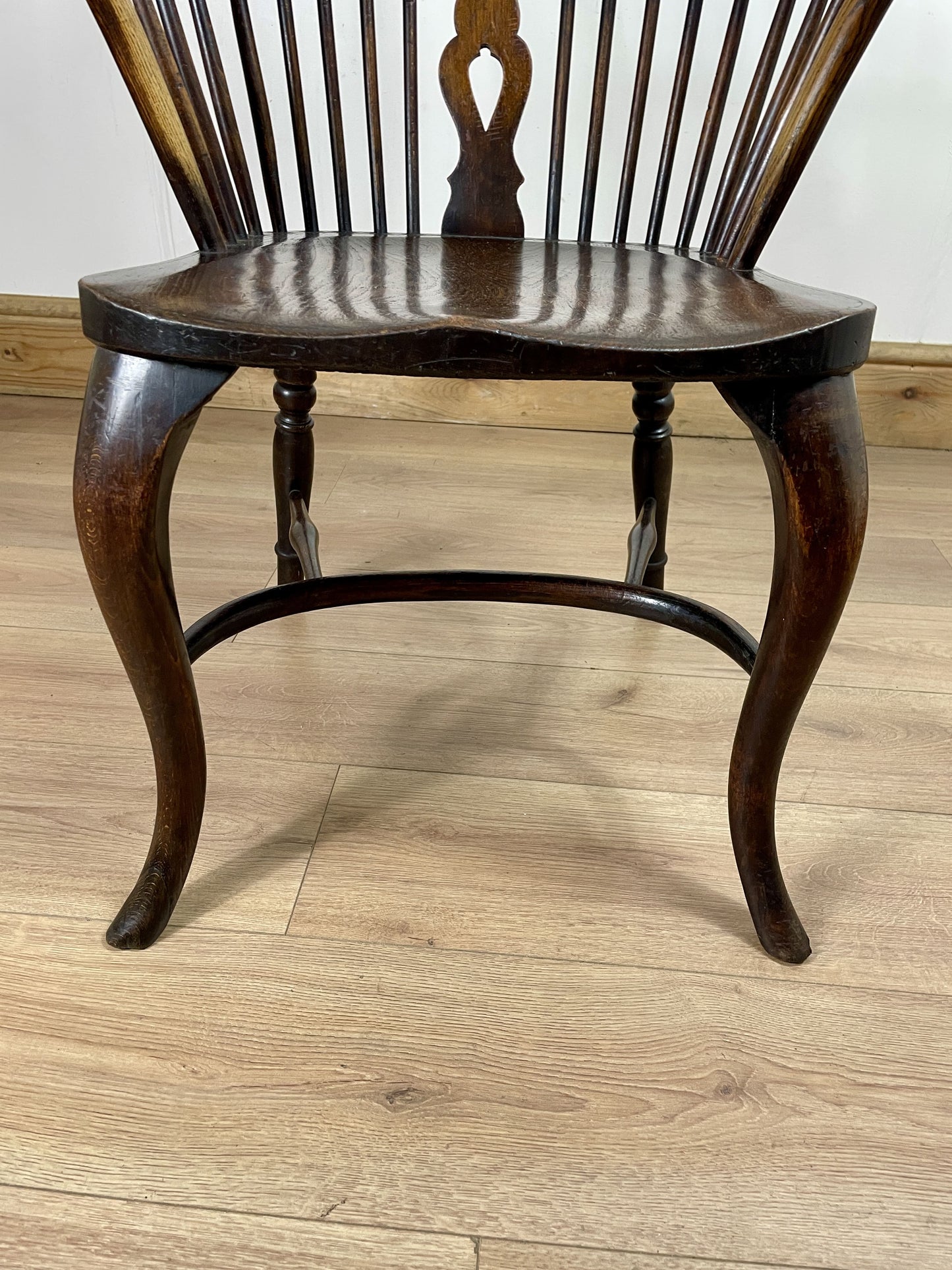 Wooden chair with curved legs on a wooden floor
