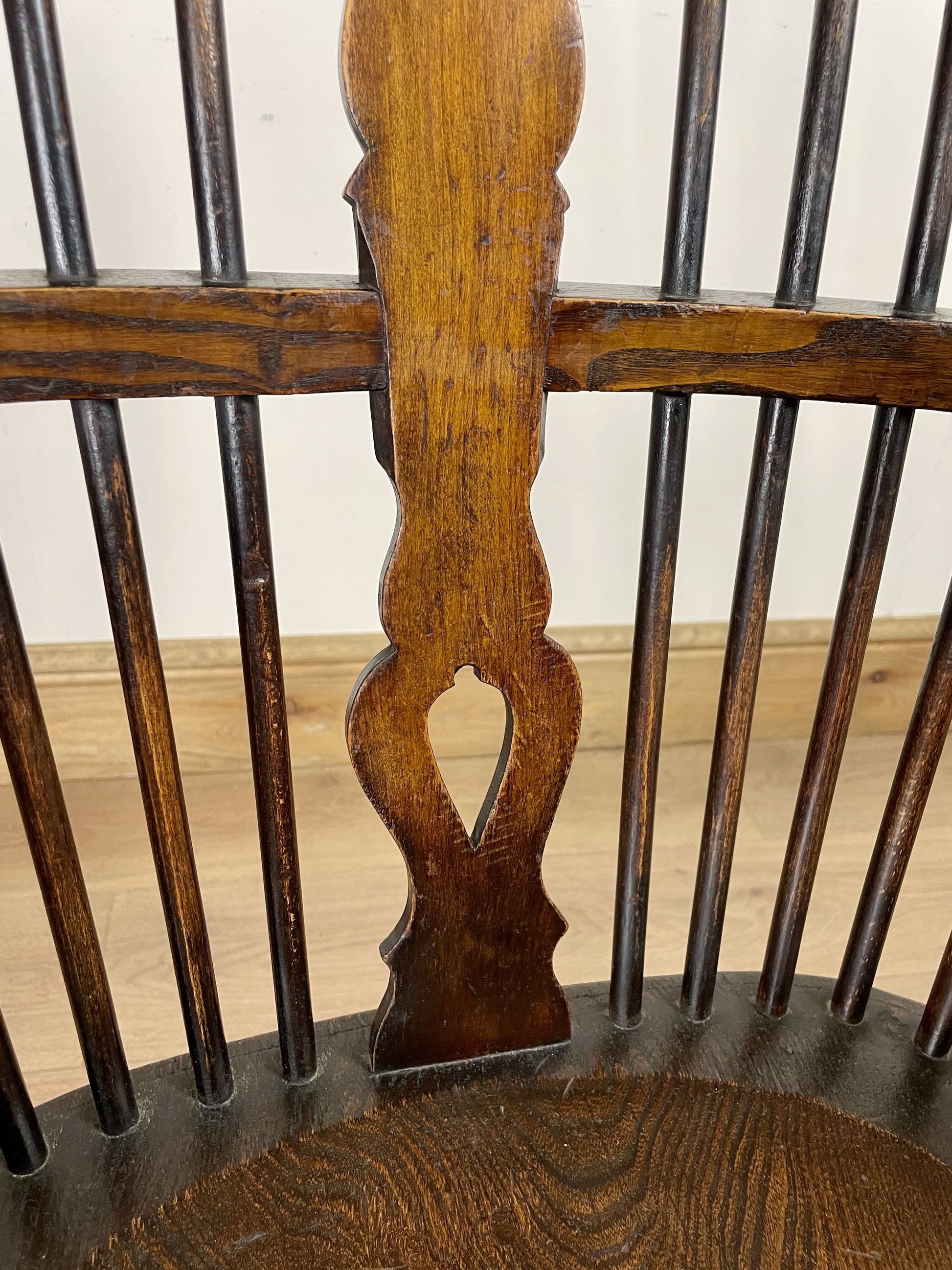 Close-up of a wooden chair with intricate carvings on a plain background