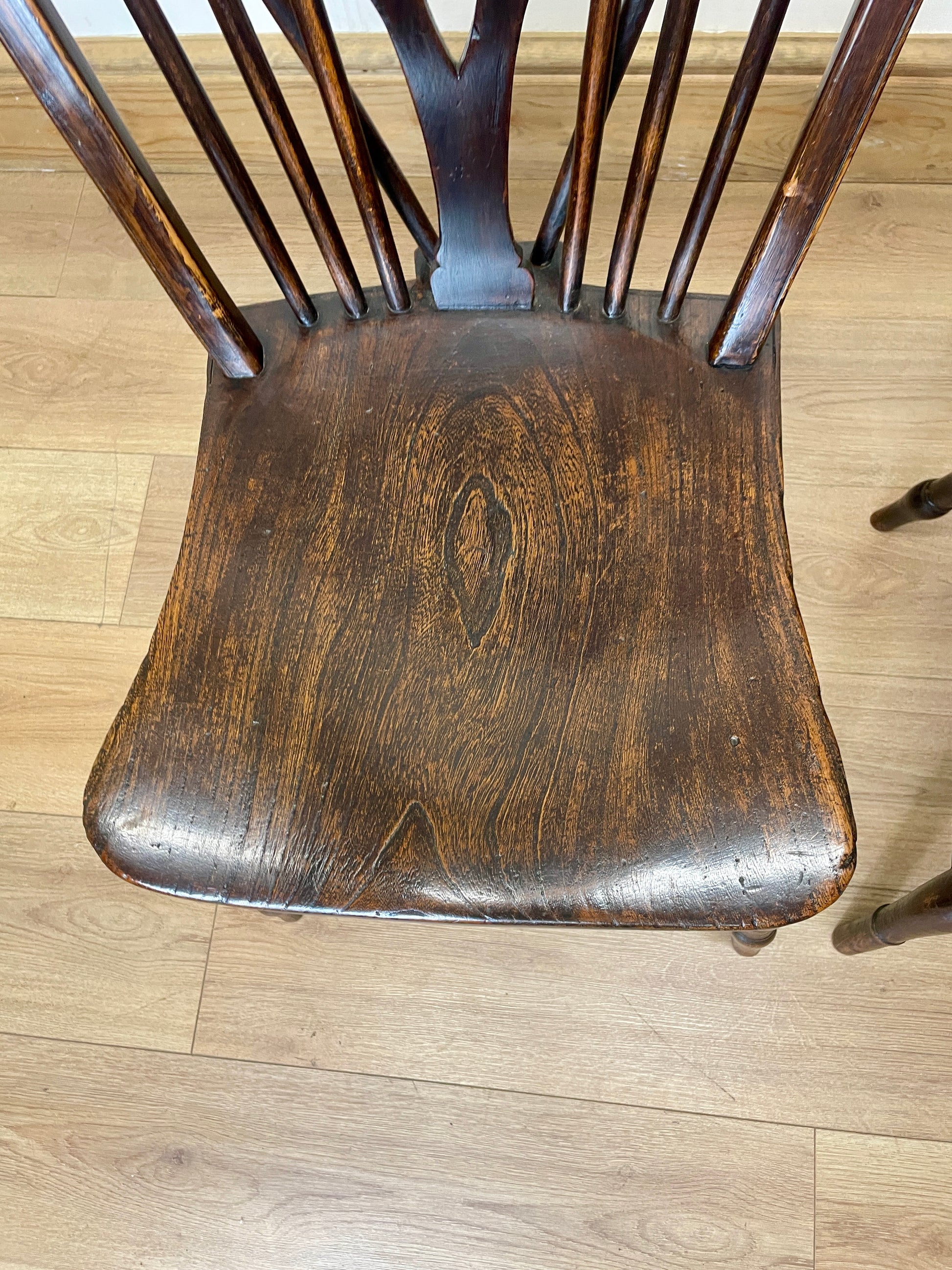 Wooden chair seat on a wooden floor
