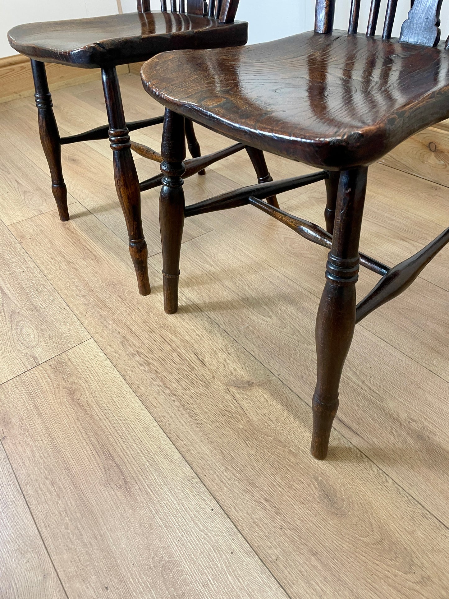 Two wooden chairs on a light wood floor
