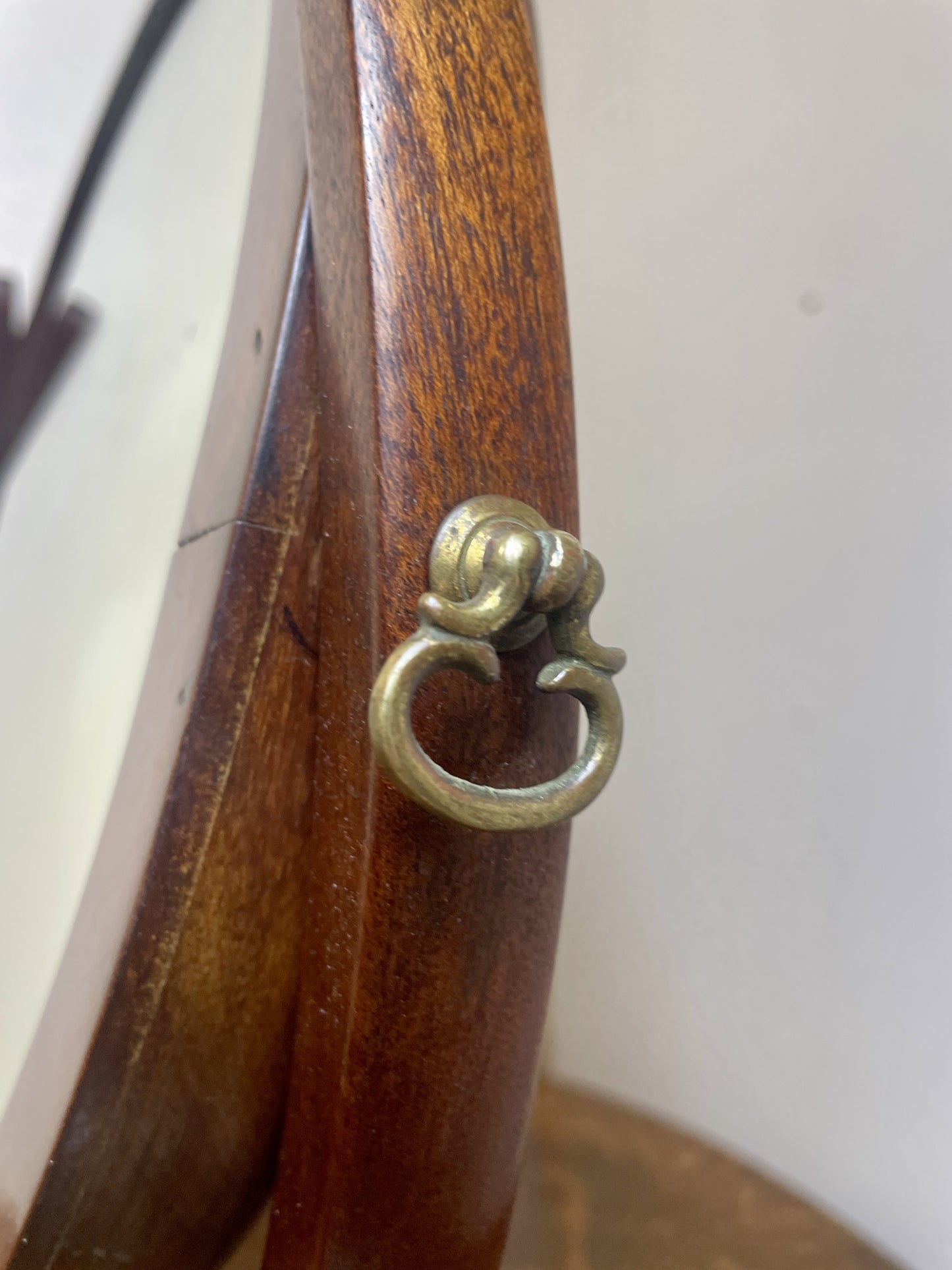 Wooden object with a brass ring detail on a white background