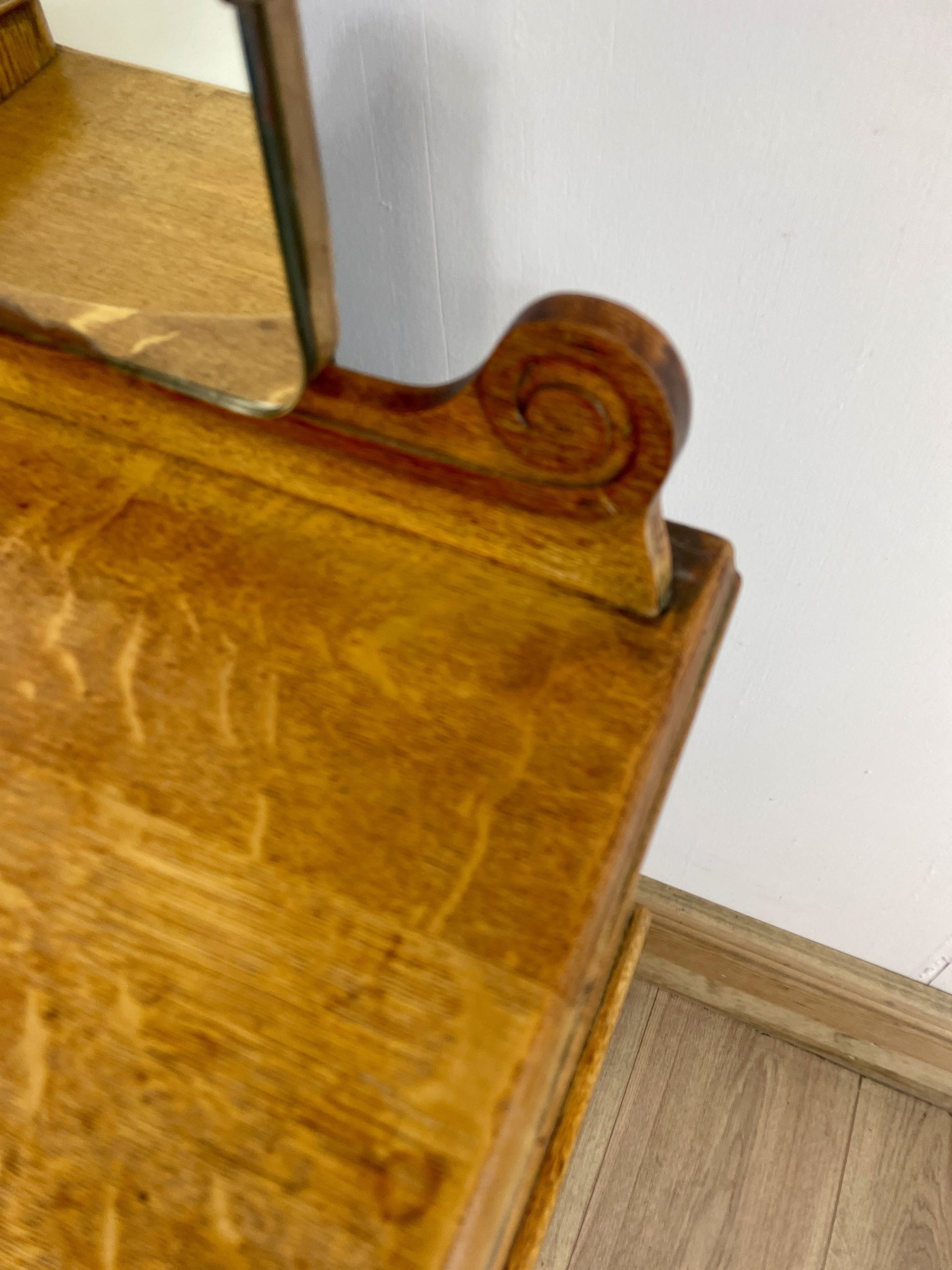 Wooden vanity with mirror on a white wall