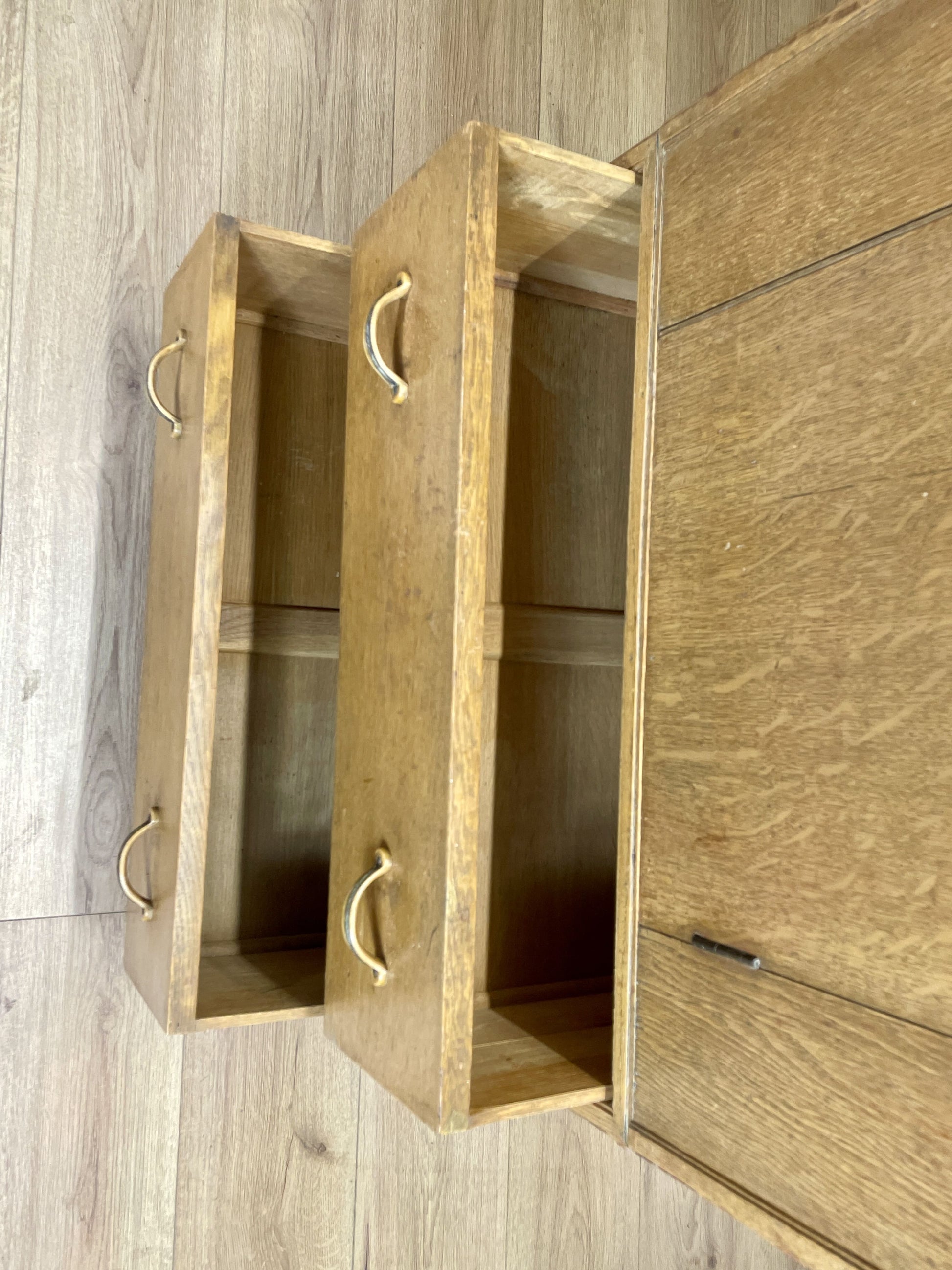 Wooden cabinet with open doors on a wooden floor