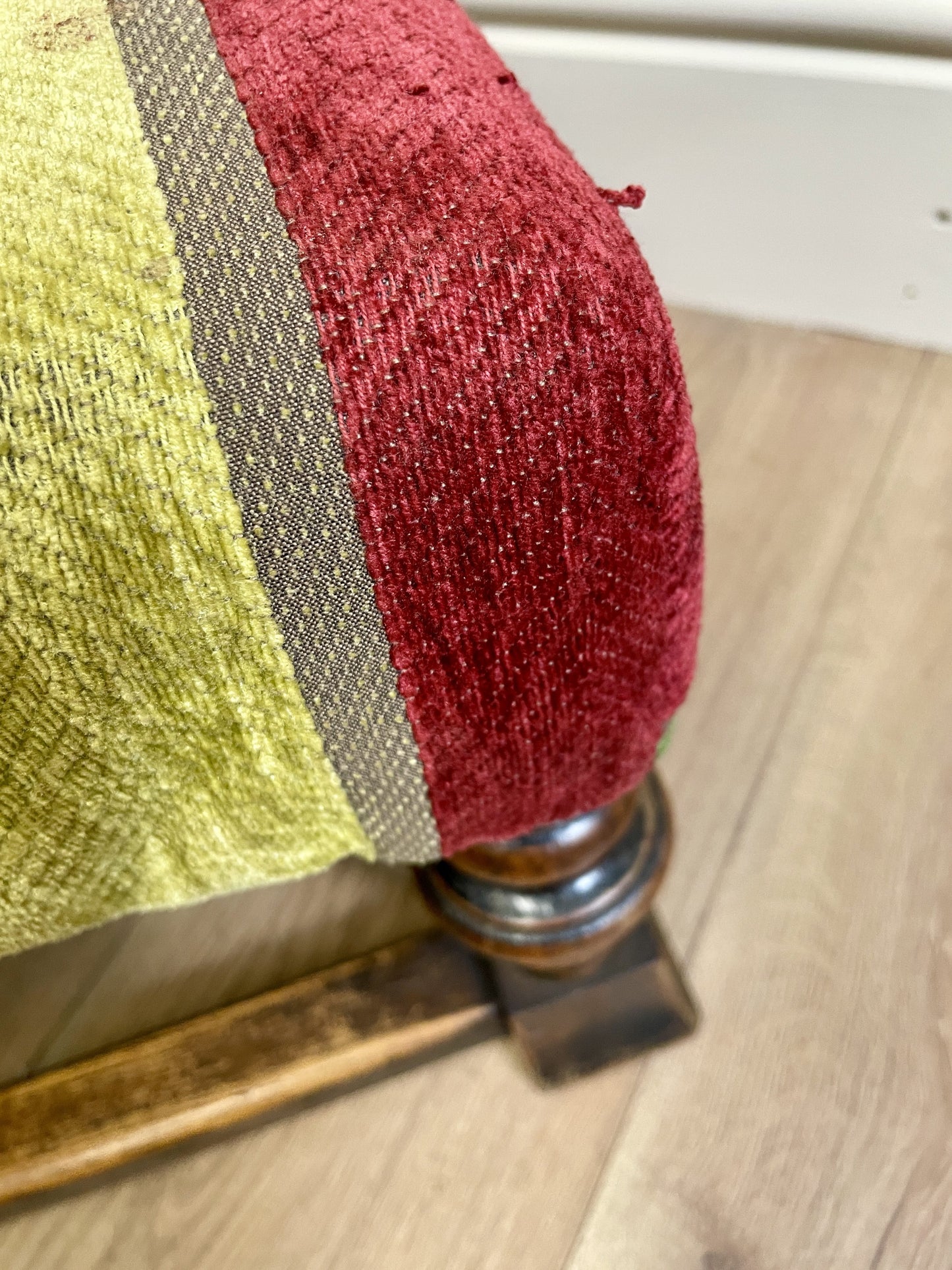 Vintage solid oak long low footstool with multicoloured upholstery and turned legs. Restored, sturdy and full of charm – a perfect accent for any living space.