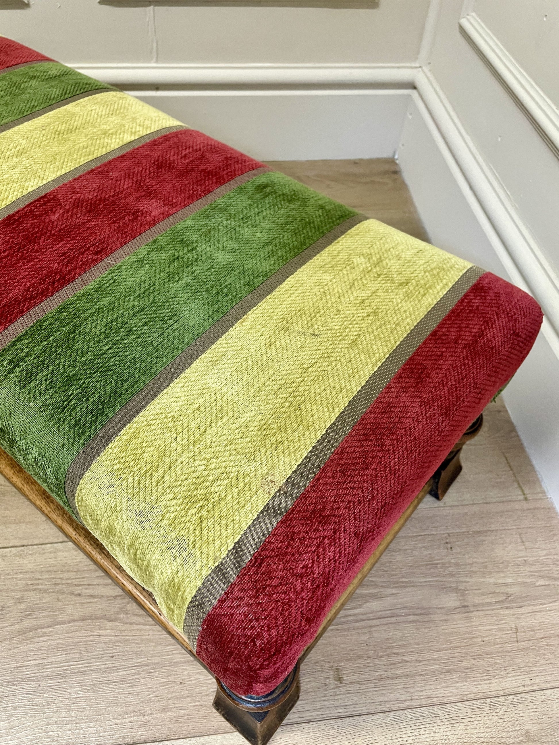 Vintage solid oak long low footstool with multicoloured upholstery and turned legs. Restored, sturdy and full of charm – a perfect accent for any living space.