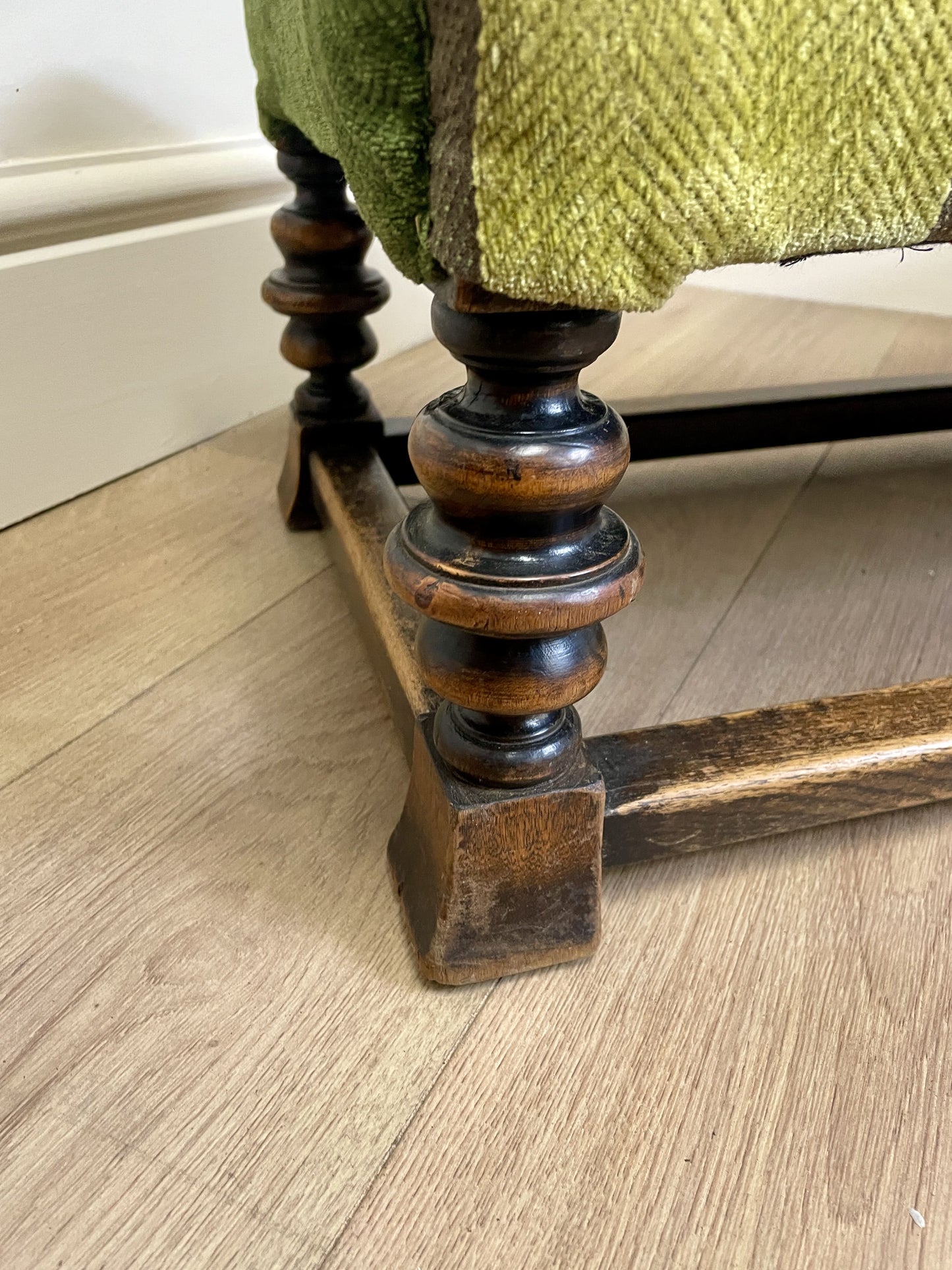 Vintage solid oak long low footstool with multicoloured upholstery and turned legs. Restored, sturdy and full of charm – a perfect accent for any living space.