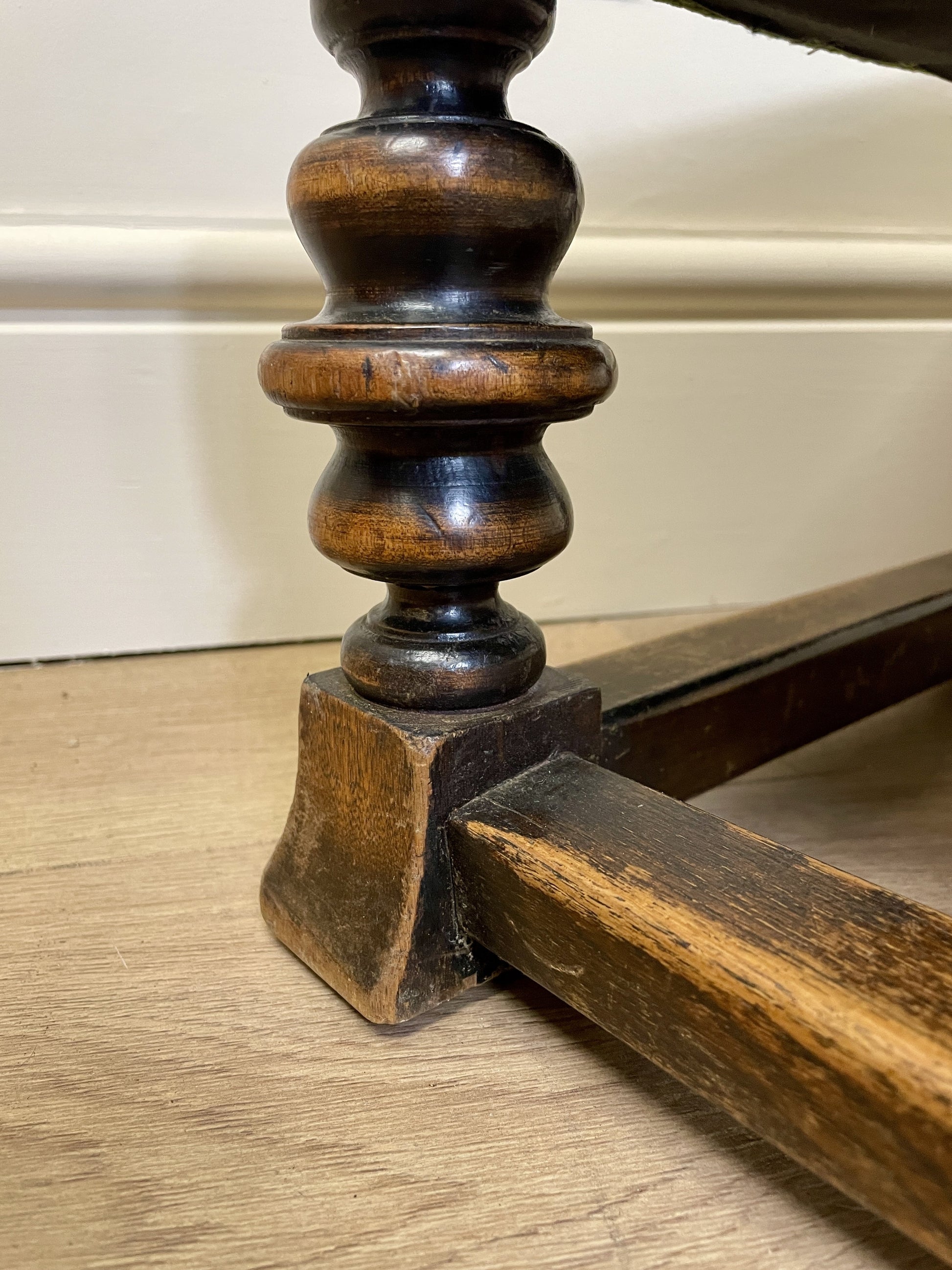 Vintage solid oak long low footstool with multicoloured upholstery and turned legs. Restored, sturdy and full of charm – a perfect accent for any living space.