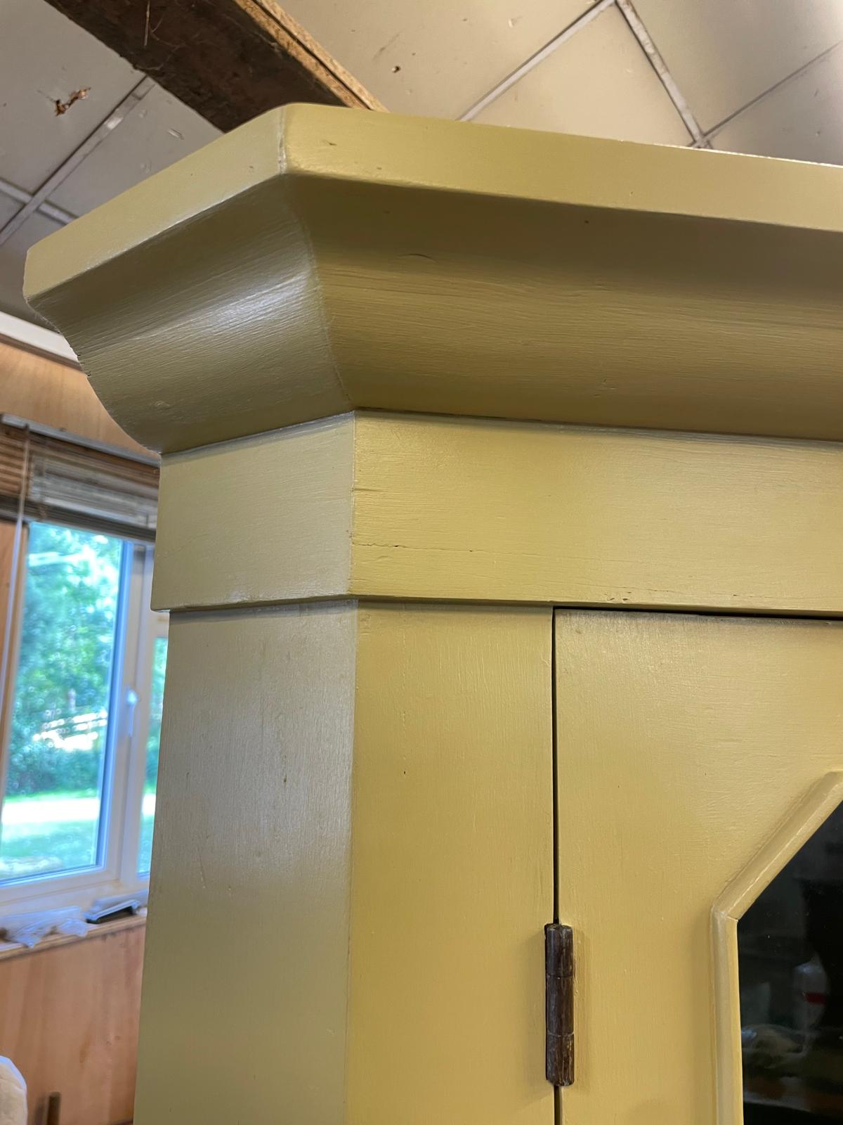 Close-up of a yellow wall with a window in the background