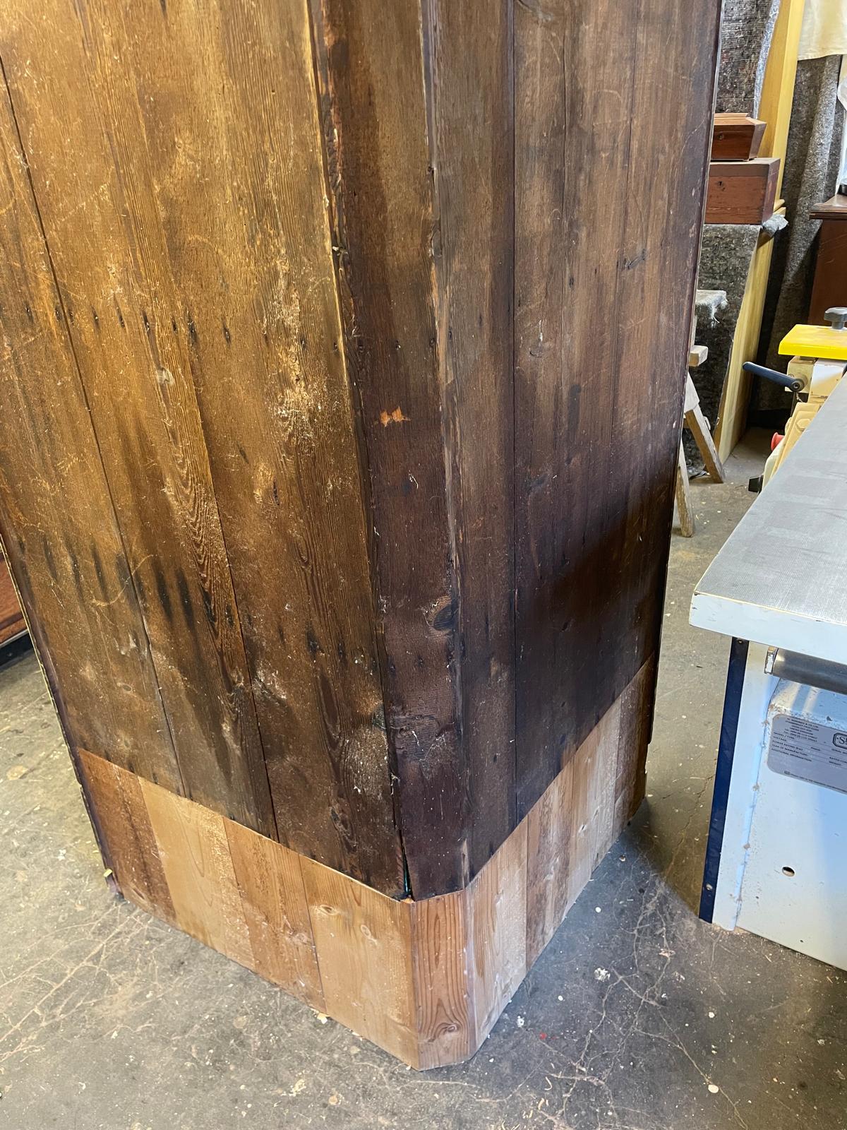Close-up of a wooden column with a rustic finish, showing visible grain and texture.