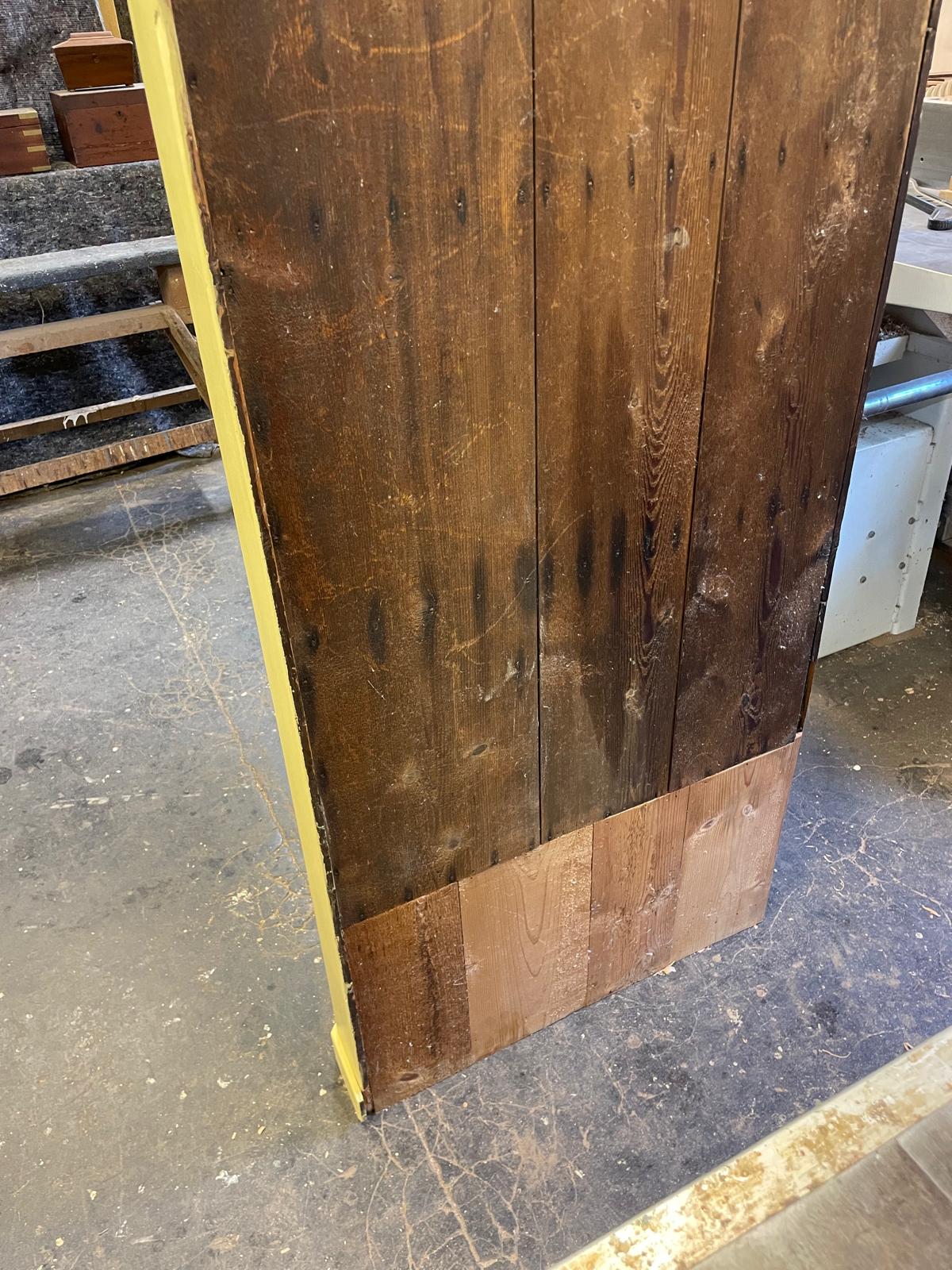 Wooden panel on a concrete floor with a yellow border