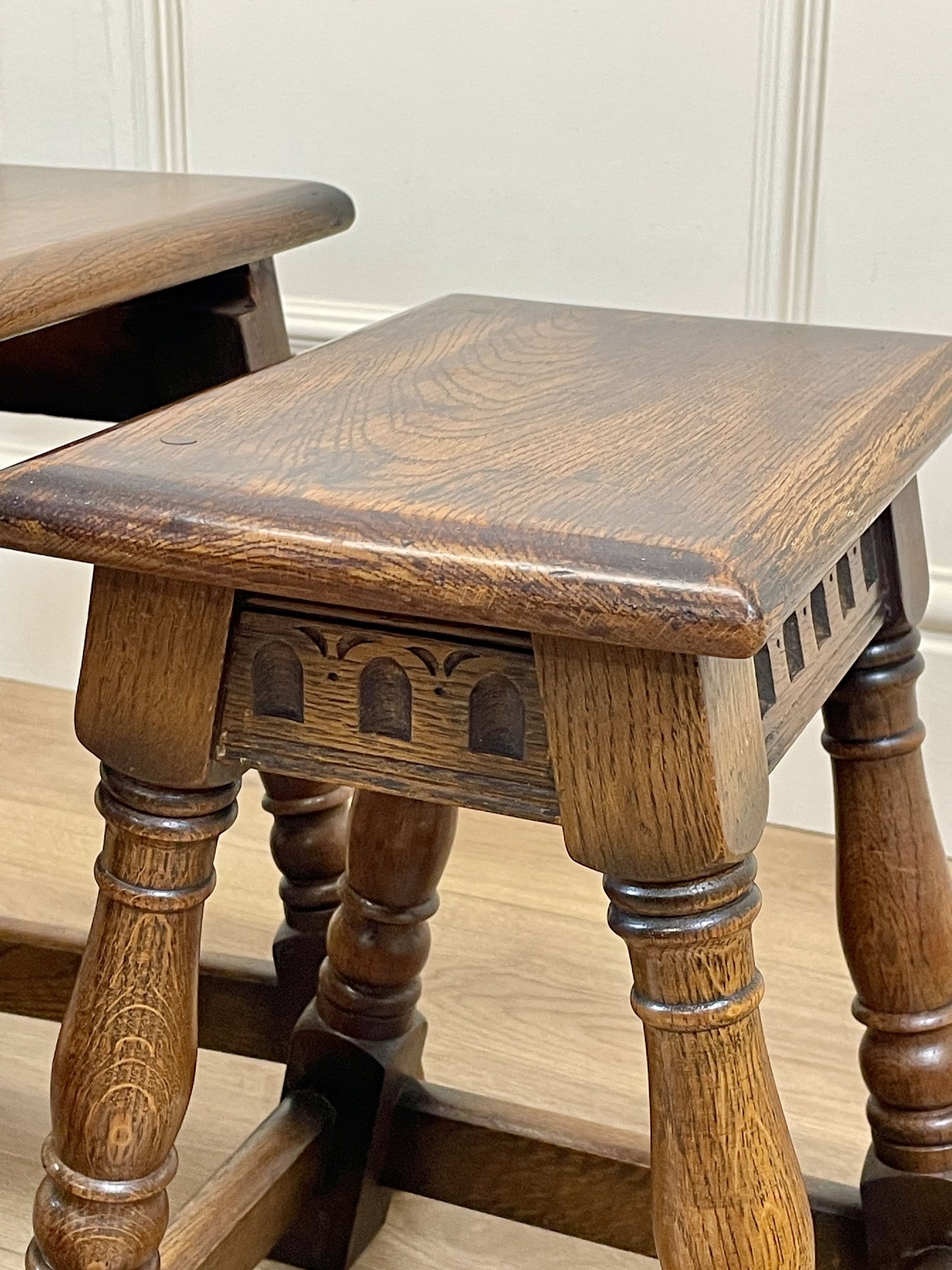 Vintage solid oak nest of 3 small tables with carved detail and splayed legs. Restored and ideal as practical antique side tables in any living room.