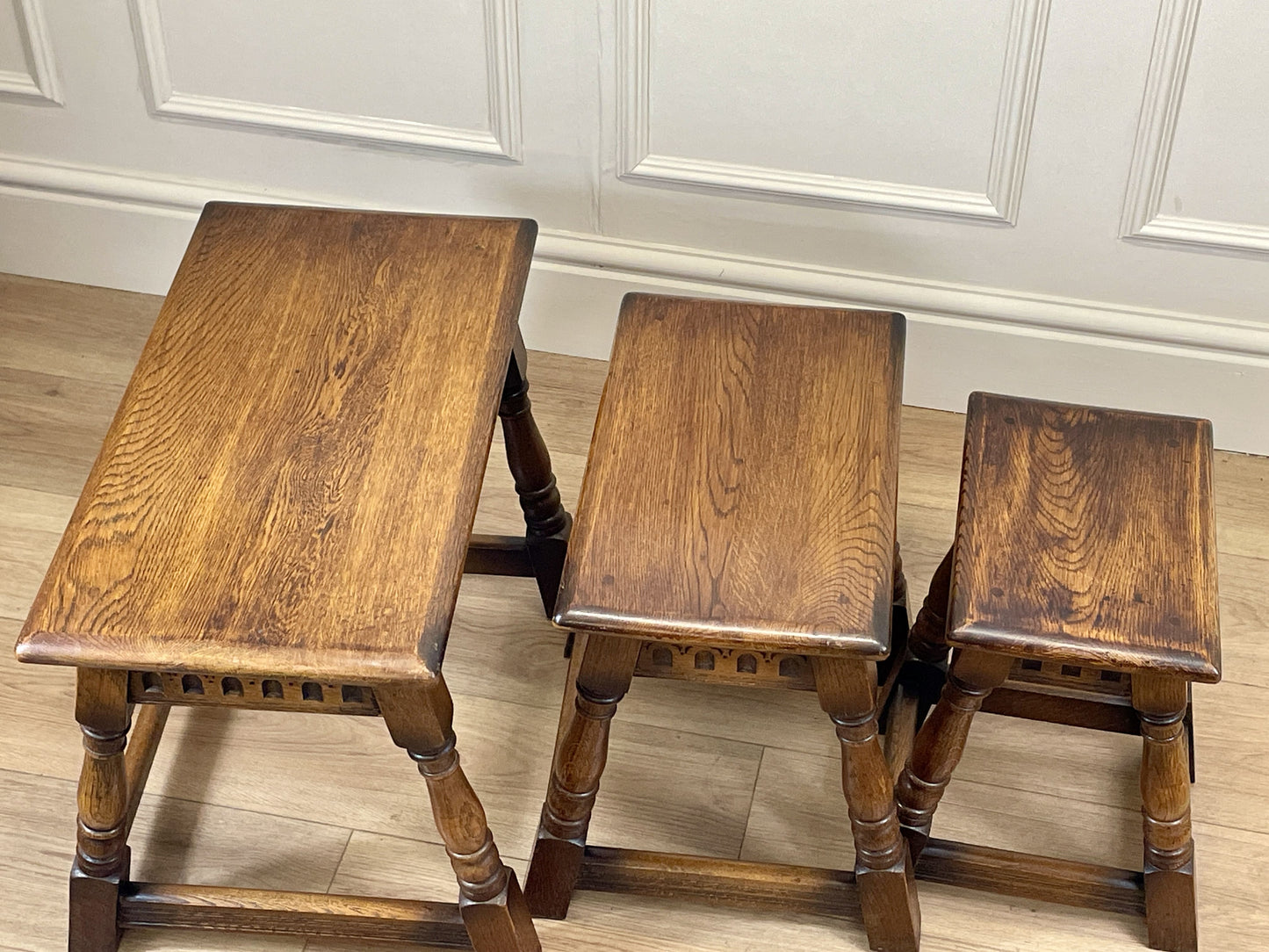 Vintage solid oak nest of 3 small tables with carved detail and splayed legs. Restored and ideal as practical antique side tables in any living room.