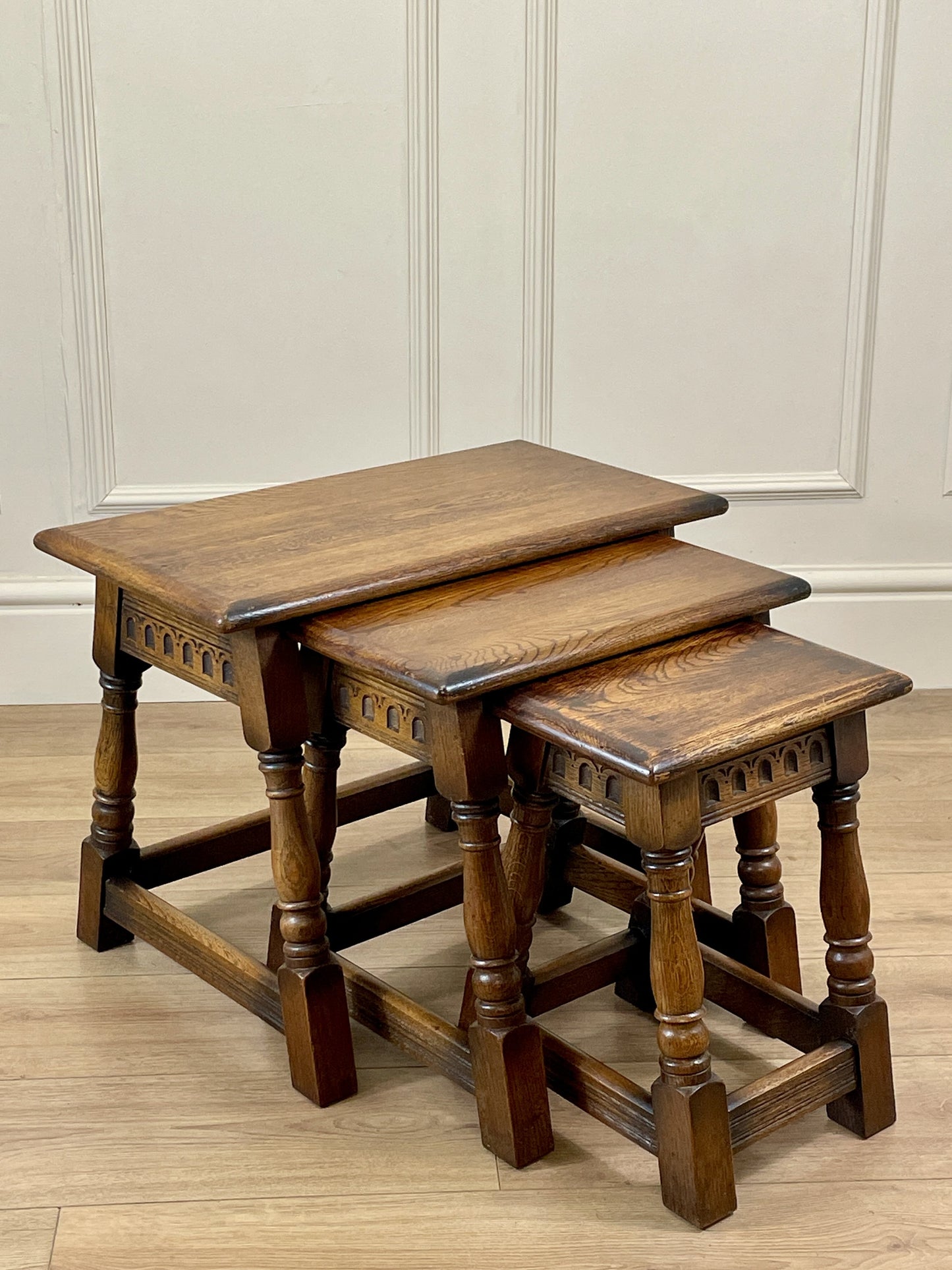 Vintage solid oak nest of 3 small tables with carved detail and splayed legs. Restored and ideal as practical antique side tables in any living room.