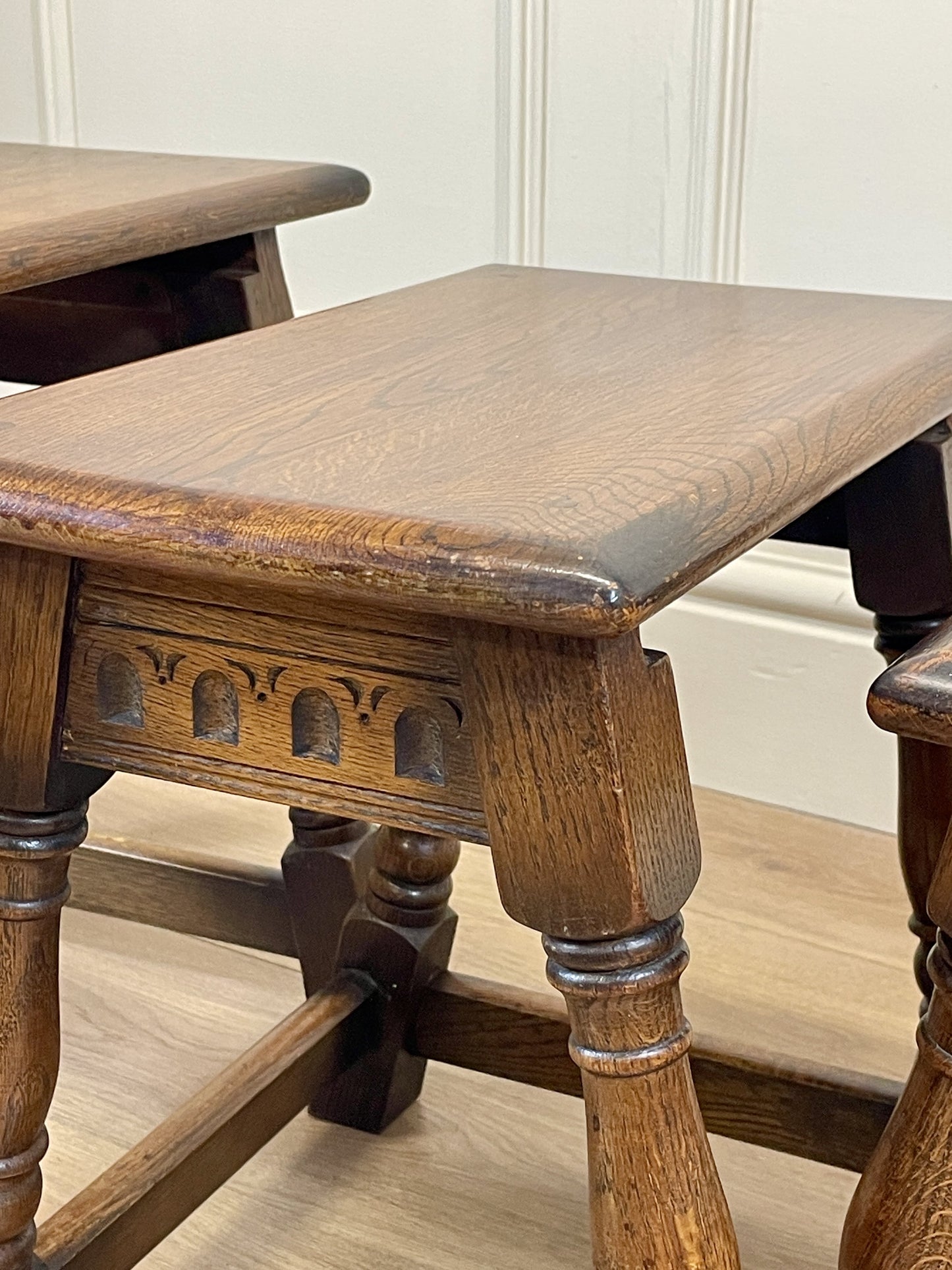 Vintage solid oak nest of 3 small tables with carved detail and splayed legs. Restored and ideal as practical antique side tables in any living room.