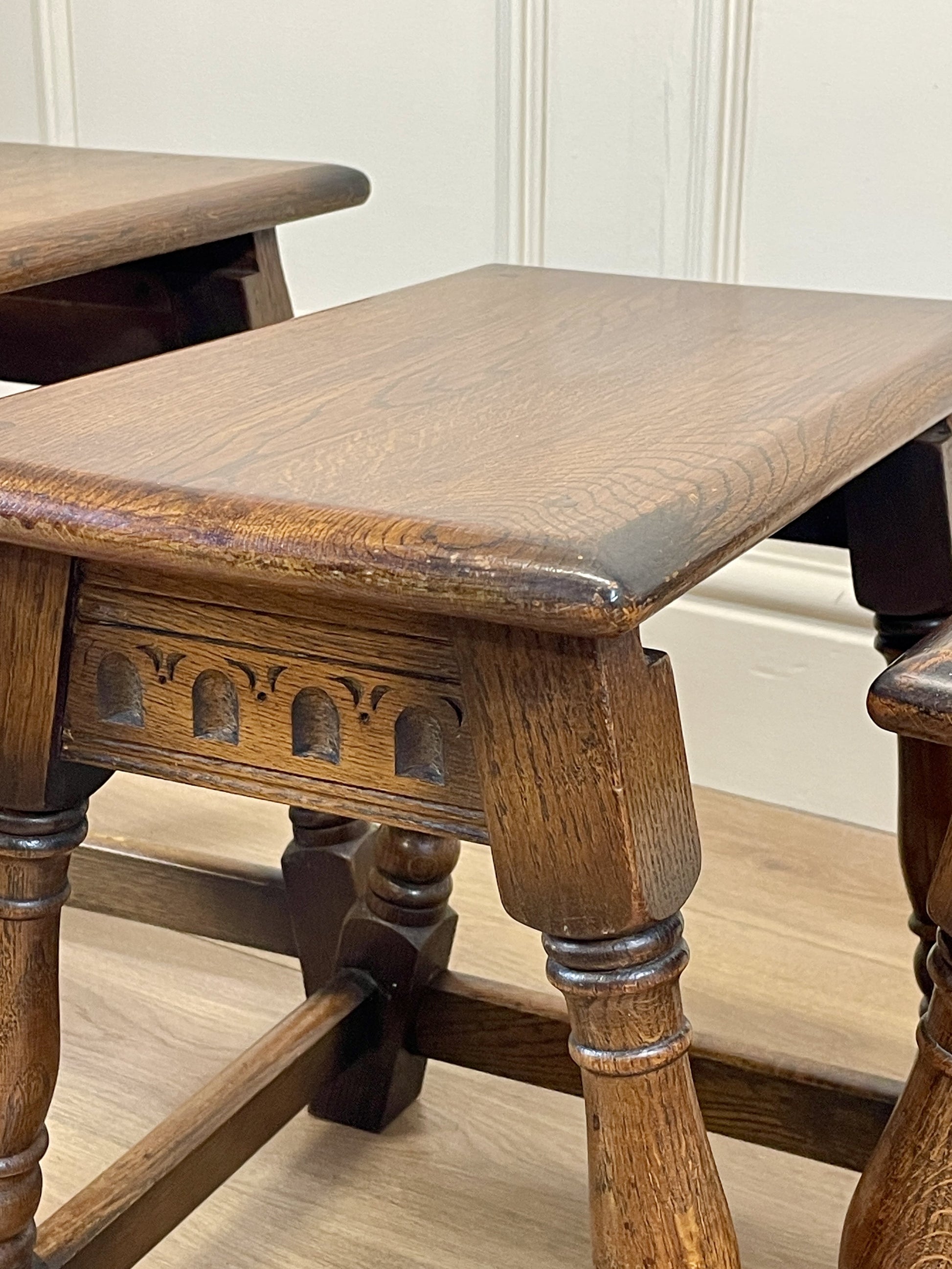 Vintage solid oak nest of 3 small tables with carved detail and splayed legs. Restored and ideal as practical antique side tables in any living room.