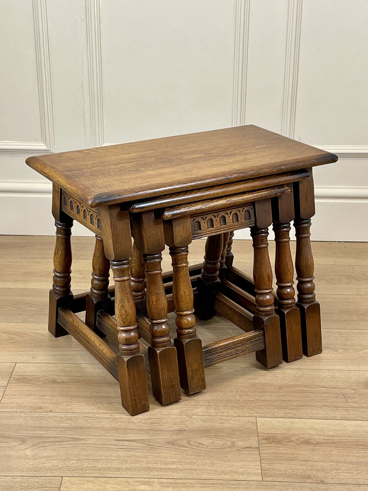 Vintage solid oak nest of 3 small tables with carved detail and splayed legs. Restored and ideal as practical antique side tables in any living room.