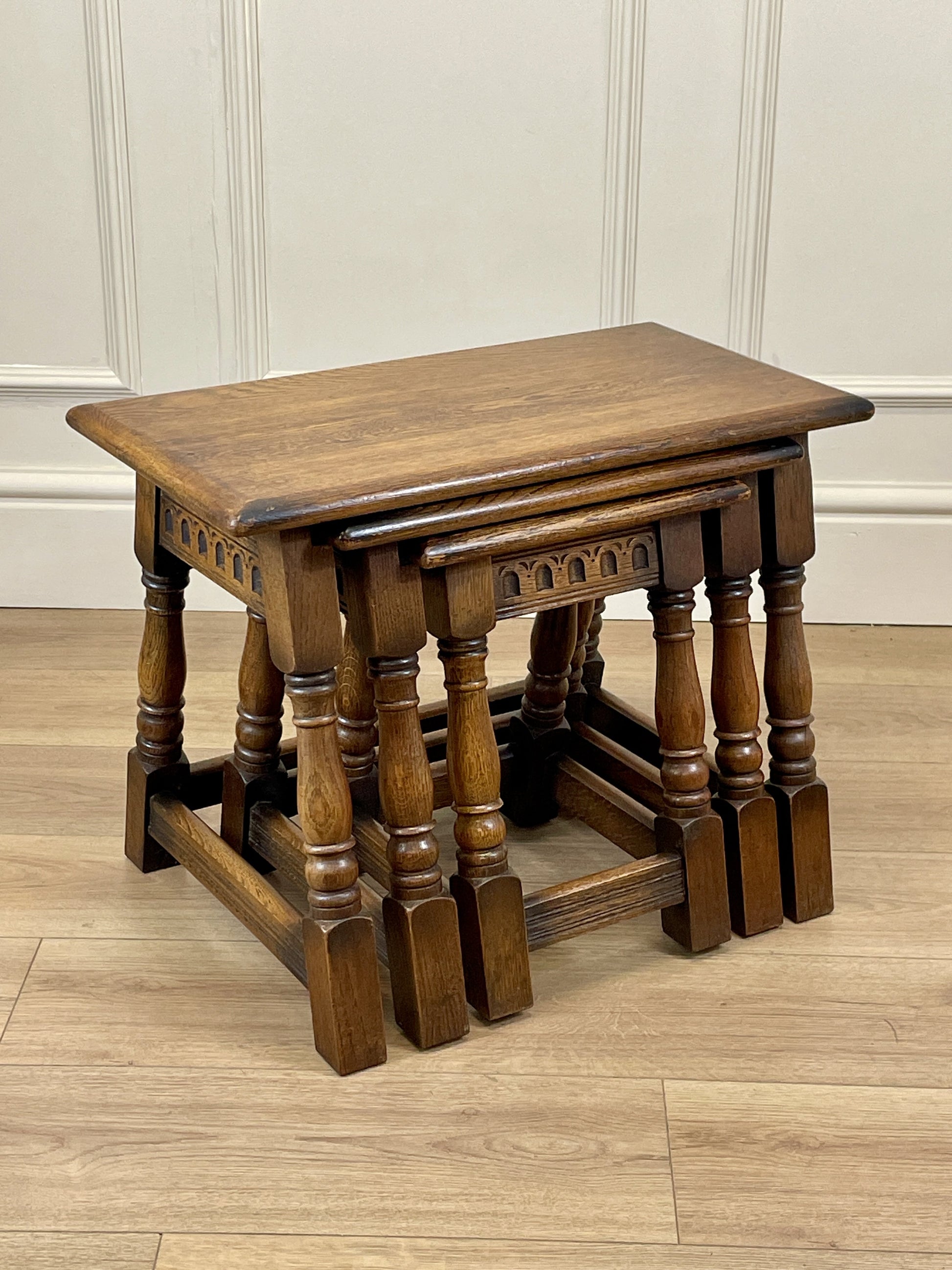 Vintage solid oak nest of 3 small tables with carved detail and splayed legs. Restored and ideal as practical antique side tables in any living room.