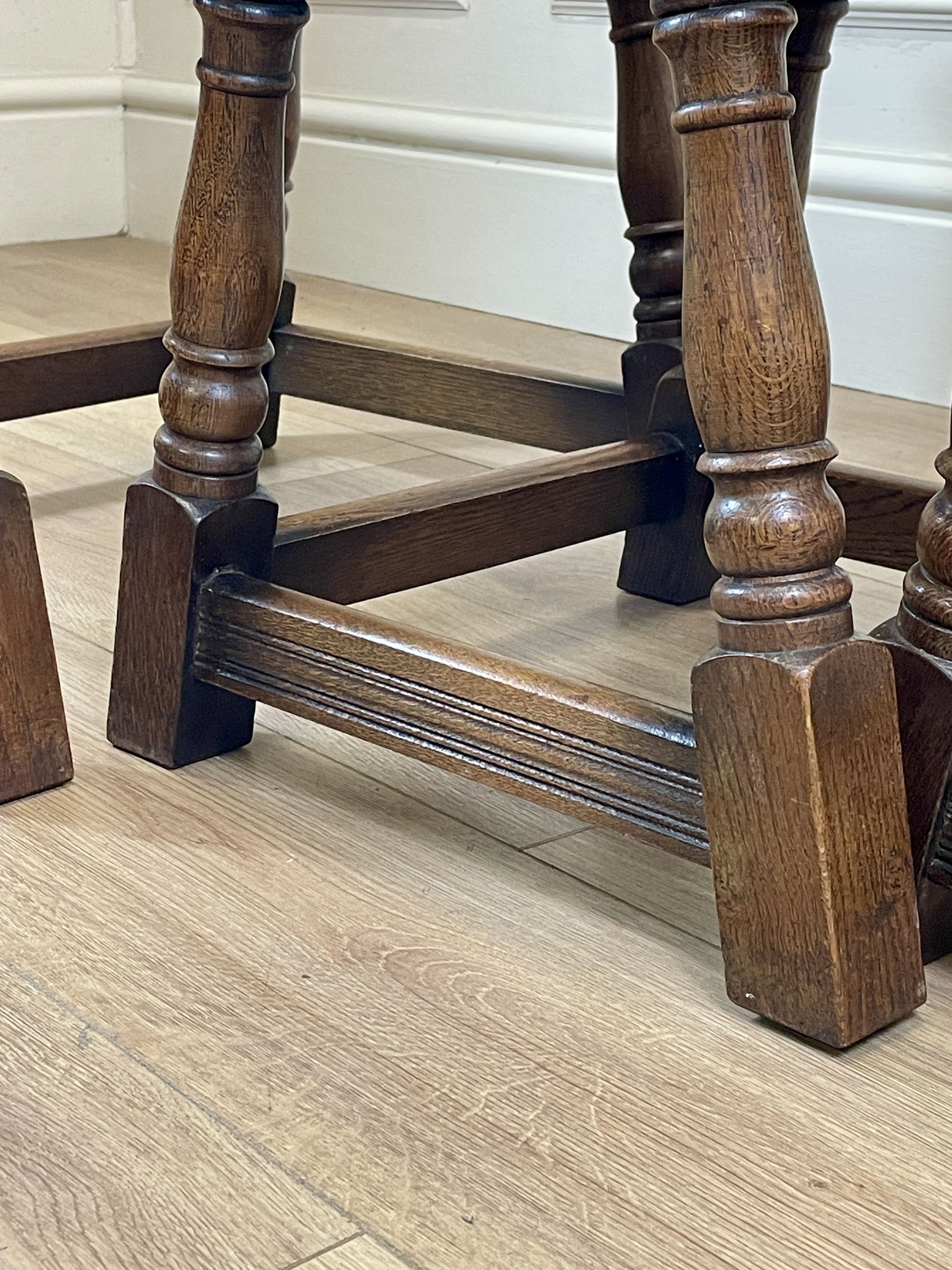 Vintage solid oak nest of 3 small tables with carved detail and splayed legs. Restored and ideal as practical antique side tables in any living room.