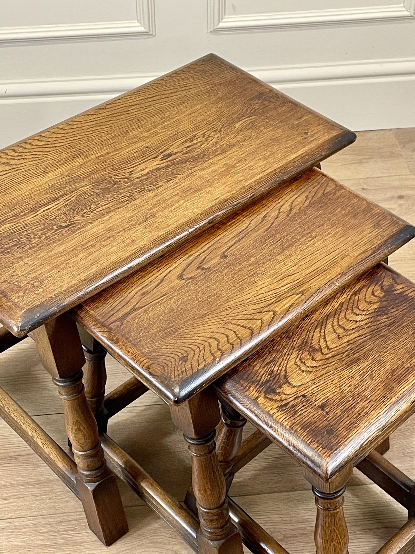 Vintage solid oak nest of 3 small tables with carved detail and splayed legs. Restored and ideal as practical antique side tables in any living room.