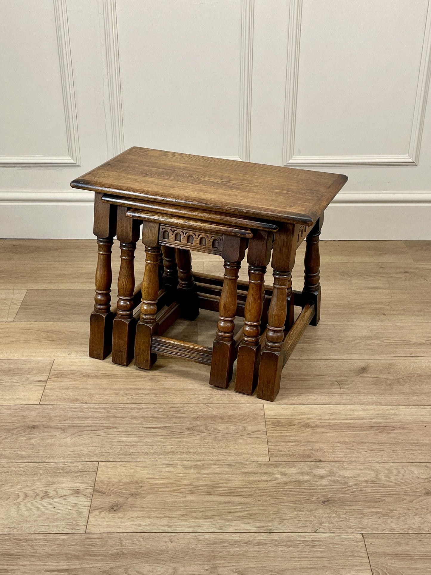 Vintage solid oak nest of 3 small tables with carved detail and splayed legs. Restored and ideal as practical antique side tables in any living room.