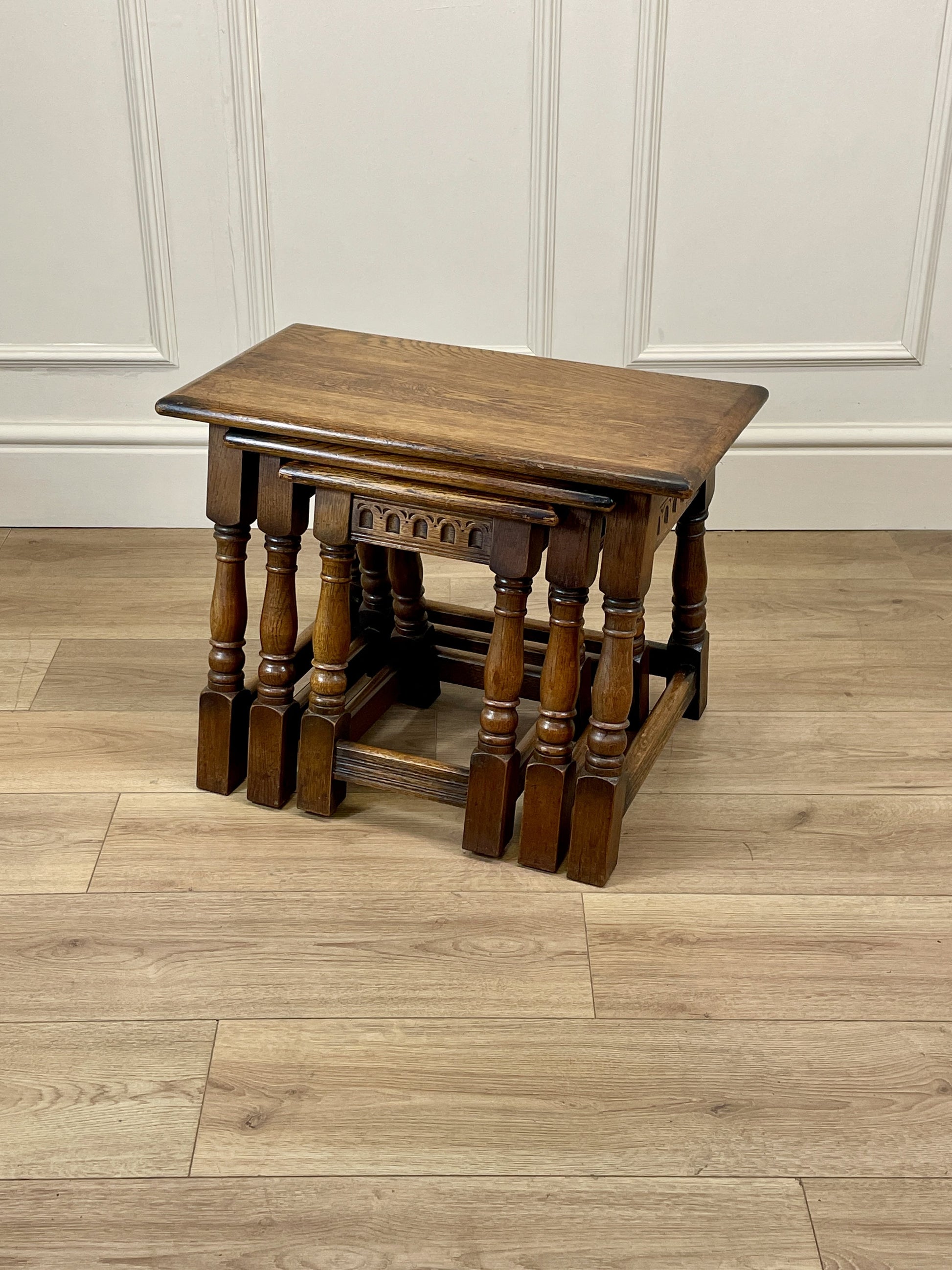 Vintage solid oak nest of 3 small tables with carved detail and splayed legs. Restored and ideal as practical antique side tables in any living room.