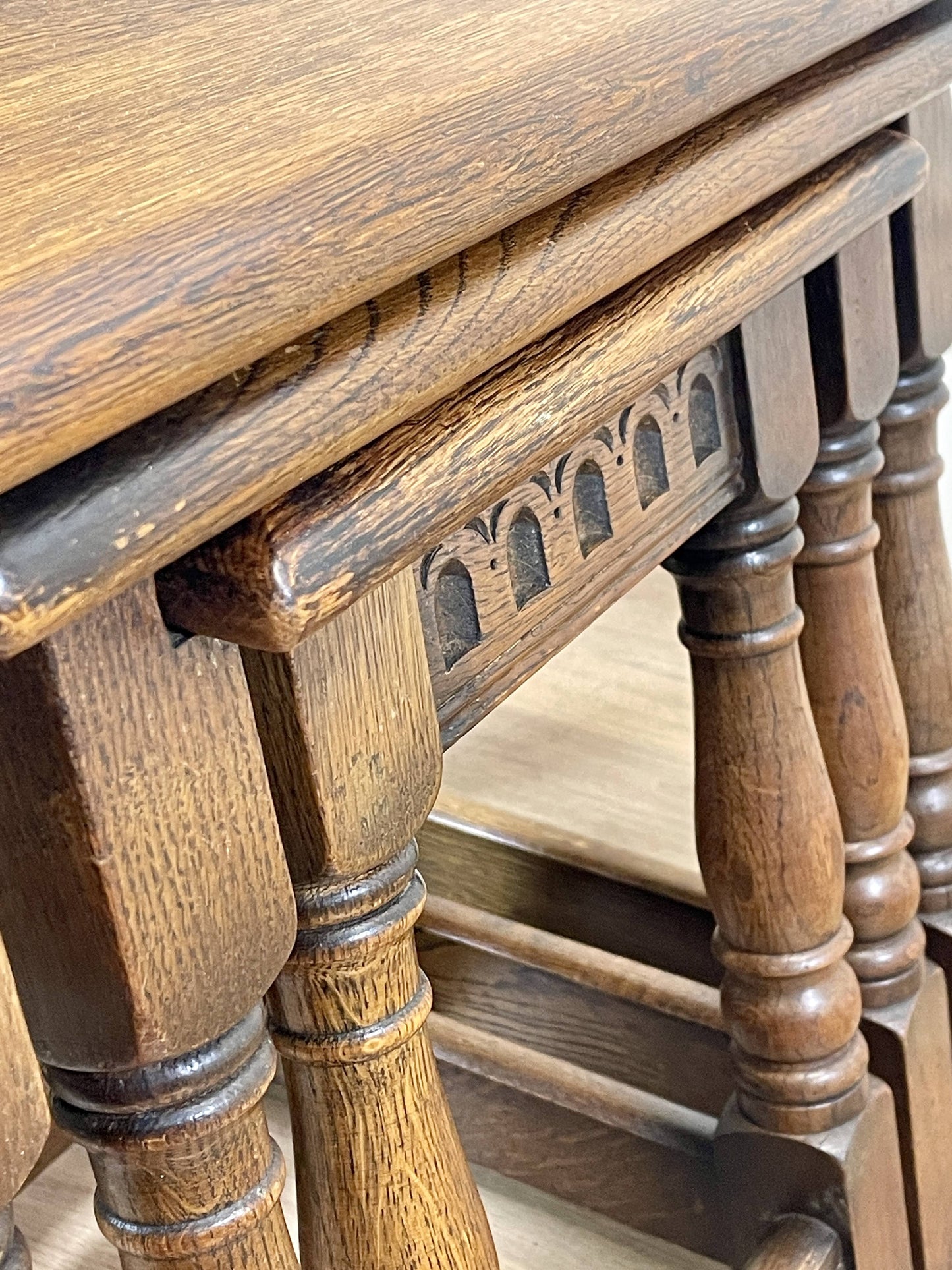 Vintage solid oak nest of 3 small tables with carved detail and splayed legs. Restored and ideal as practical antique side tables in any living room.