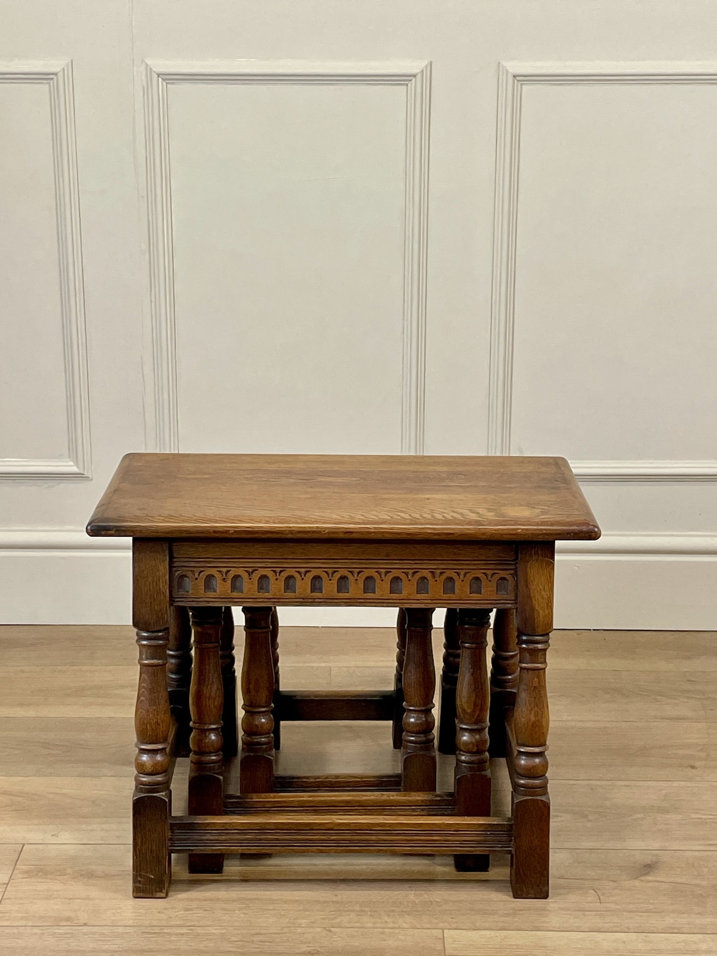 Vintage solid oak nest of 3 small tables with carved detail and splayed legs. Restored and ideal as practical antique side tables in any living room.
