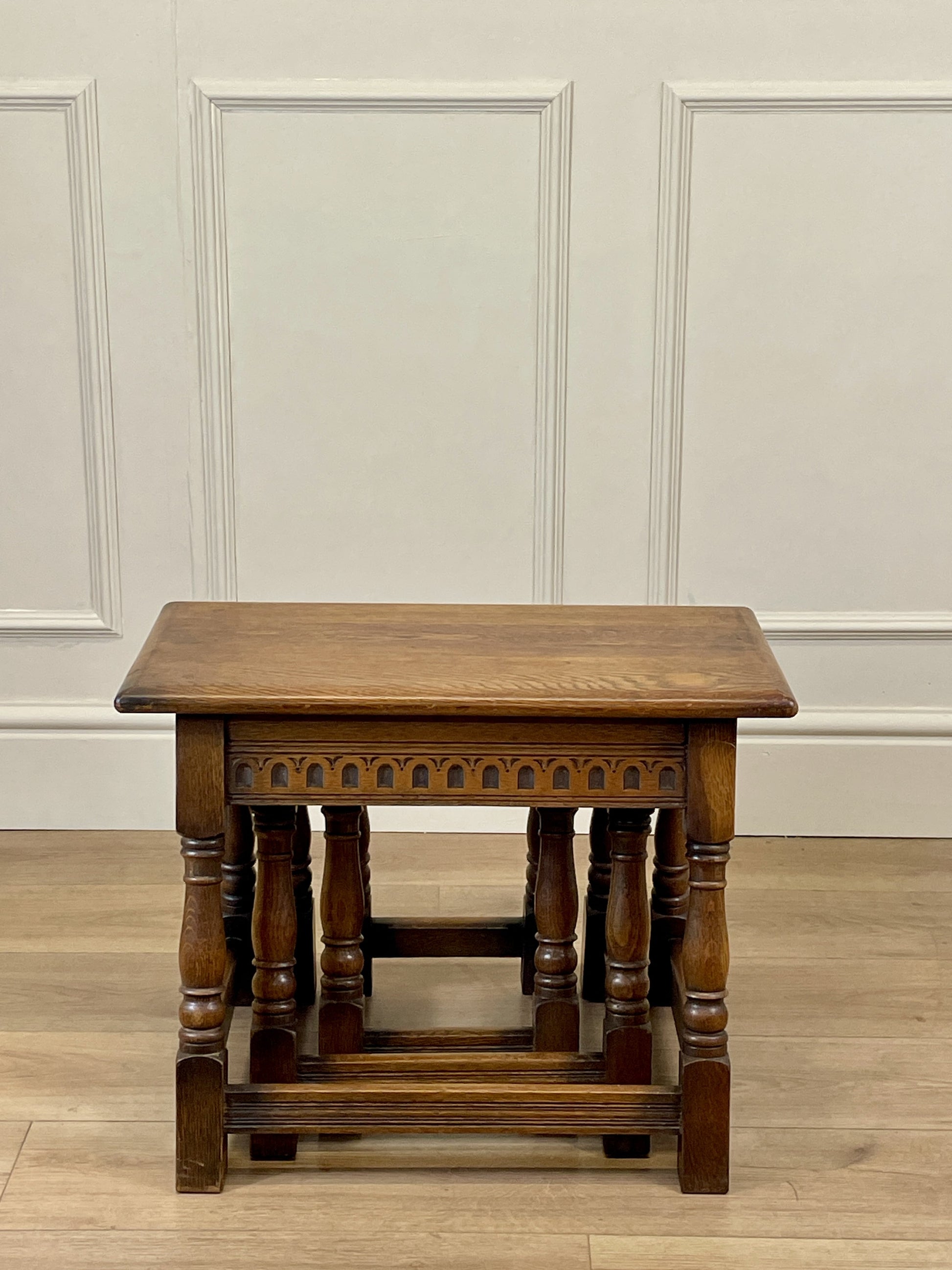 Vintage solid oak nest of 3 small tables with carved detail and splayed legs. Restored and ideal as practical antique side tables in any living room.